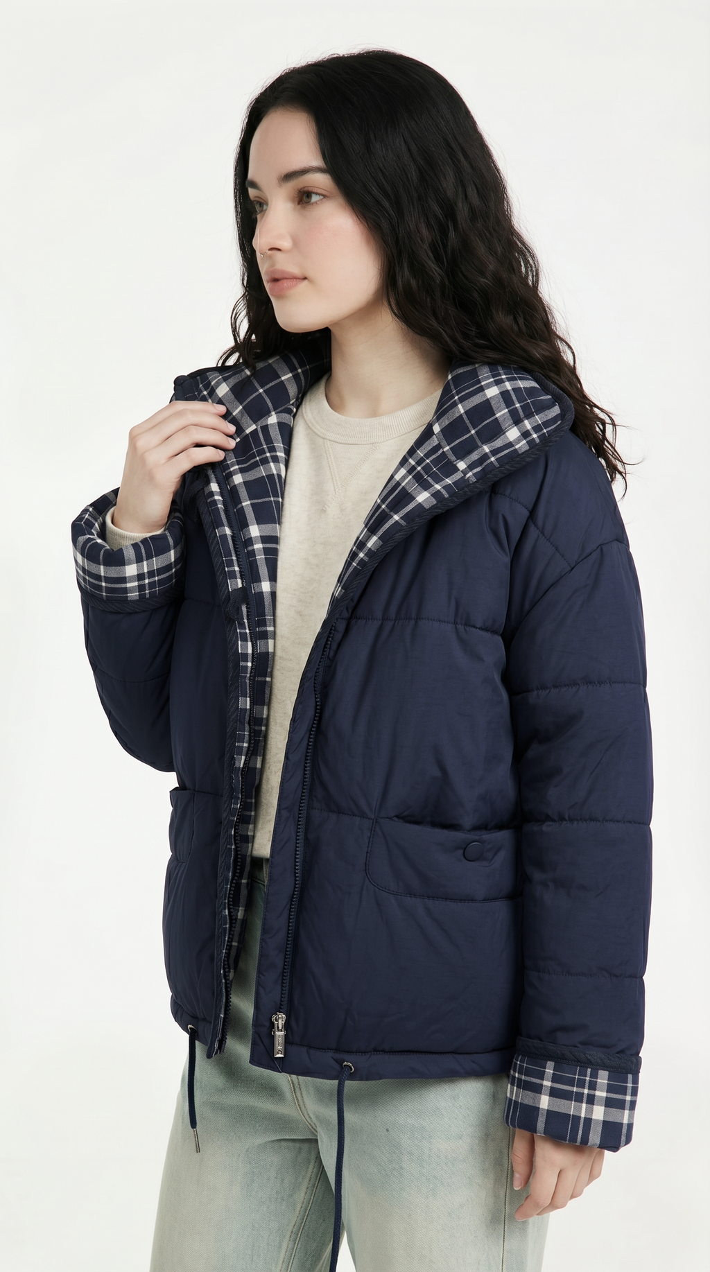 Woman wearing a navy puffer jacket with plaid lining on a white background from Meleche or Meléche USA (short as (Mé))