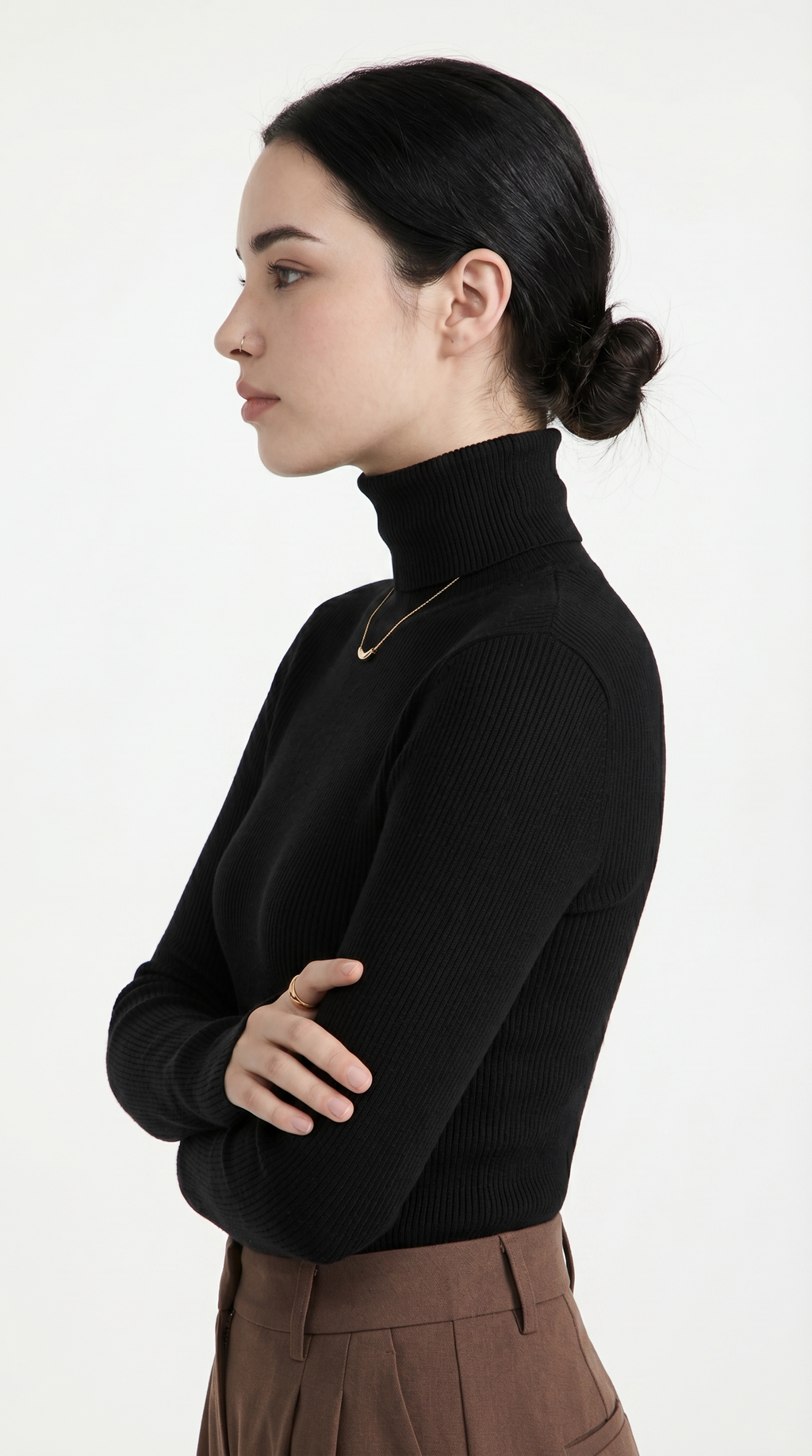 Woman wearing a black turtleneck sweater and brown pants on a white background from Meleche USA or Meléche (short as (Mé))