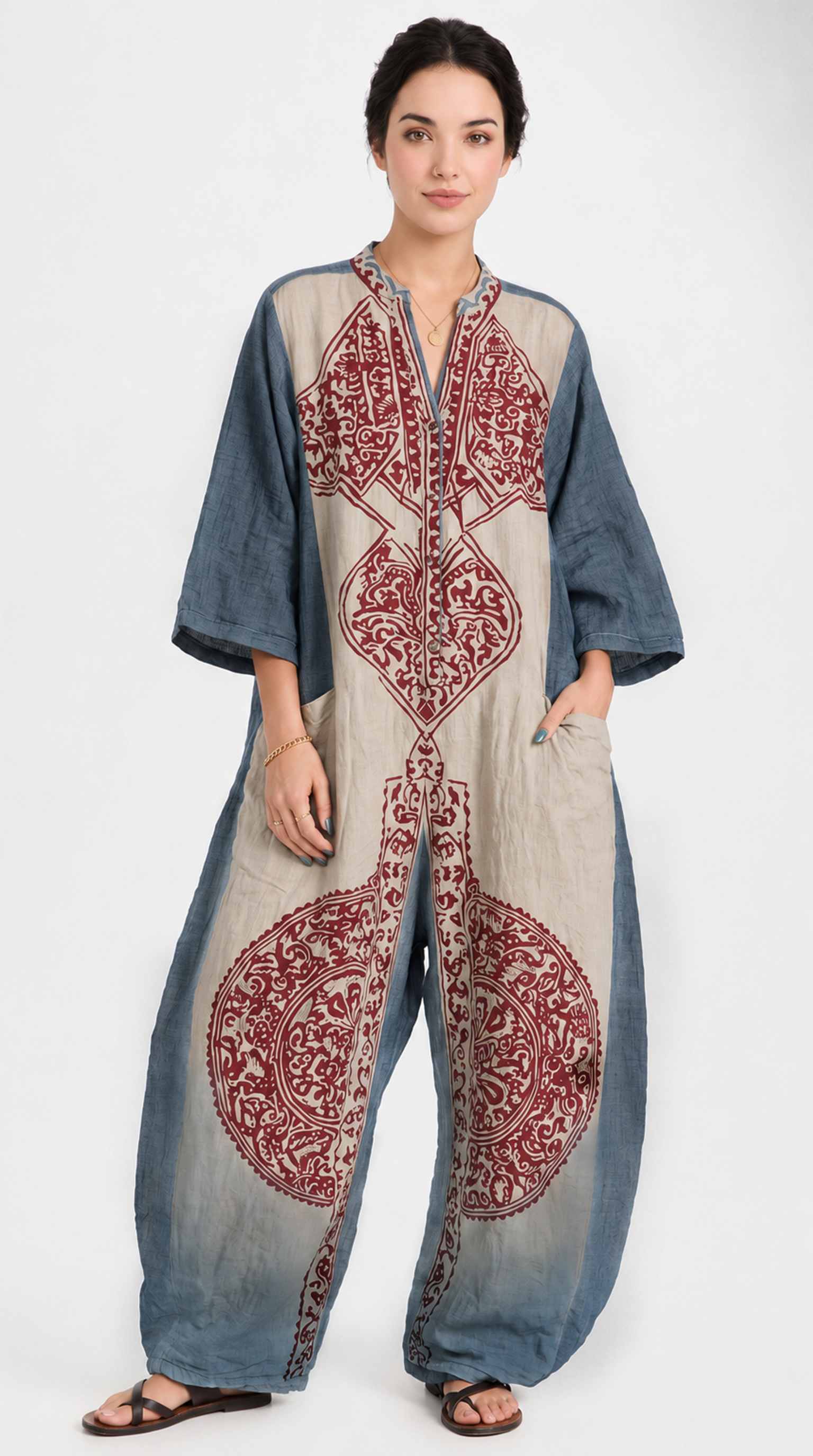 Woman wearing a long, embroidered dress with a blue and red pattern on a white background, from Meleche Fashion USA or Meléche (short as (Mé))