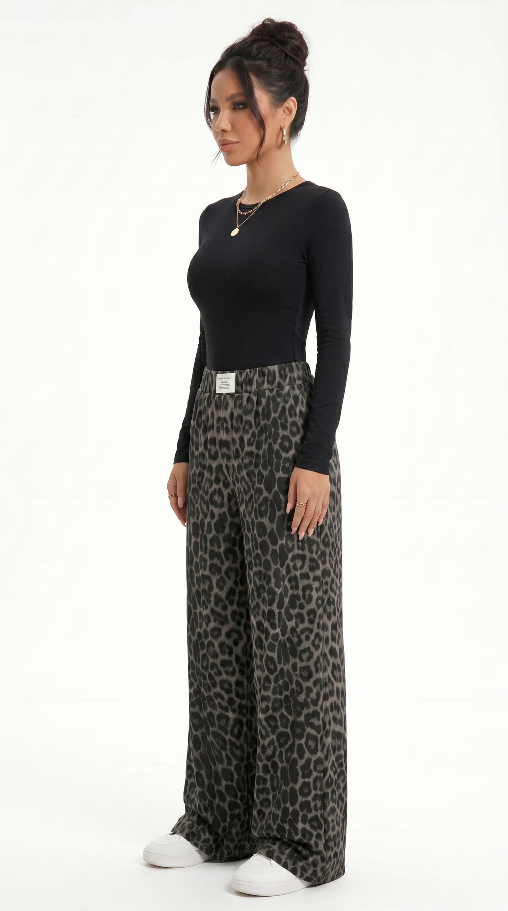 Woman wearing a black long-sleeve top and leopard print wide-leg pants on a white background, sexy pants from Meleche Fashion USA or Meléche (short as (Mé))