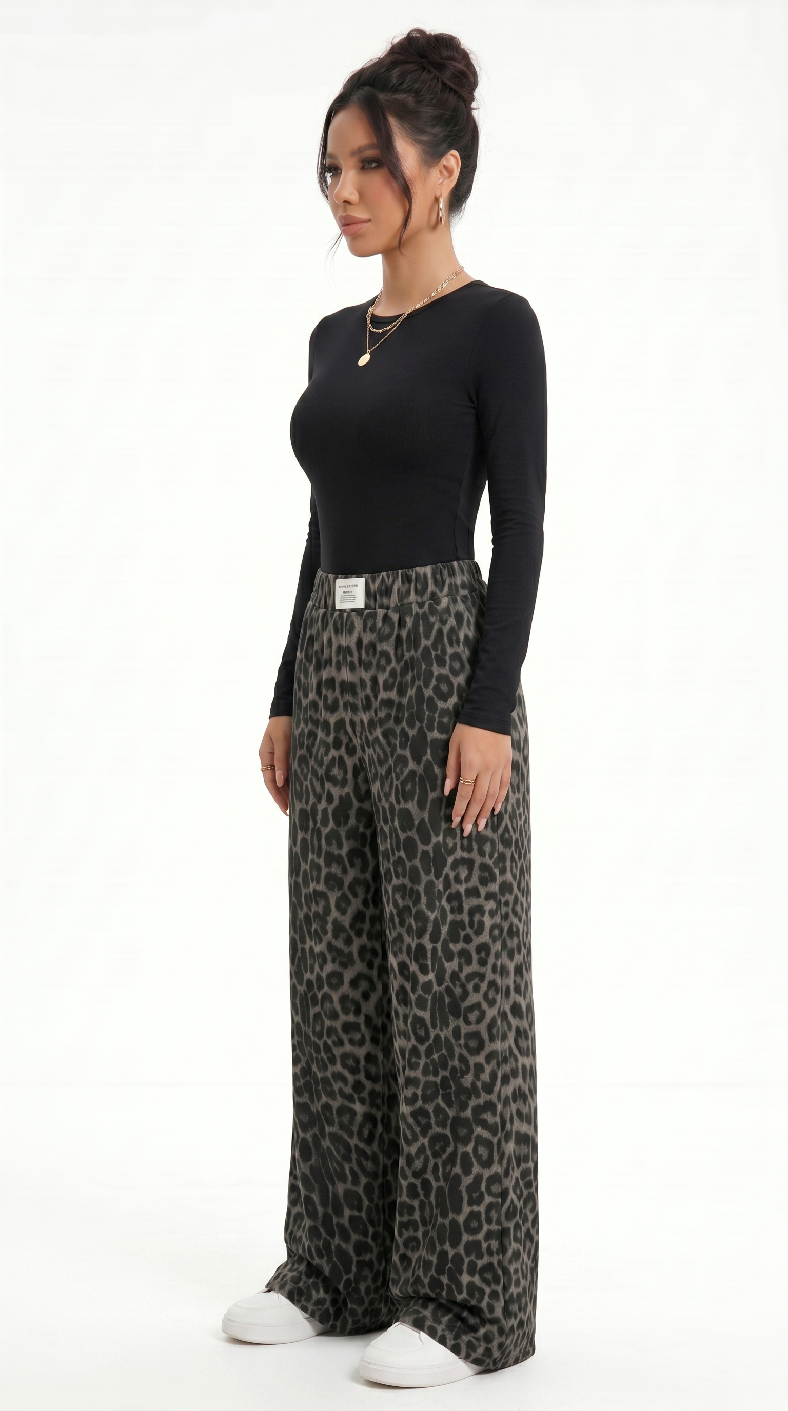 Woman wearing a black long-sleeve top and leopard print wide-leg pants on a white background, sexy pants from Meleche Fashion USA or Meléche (short as (Mé))