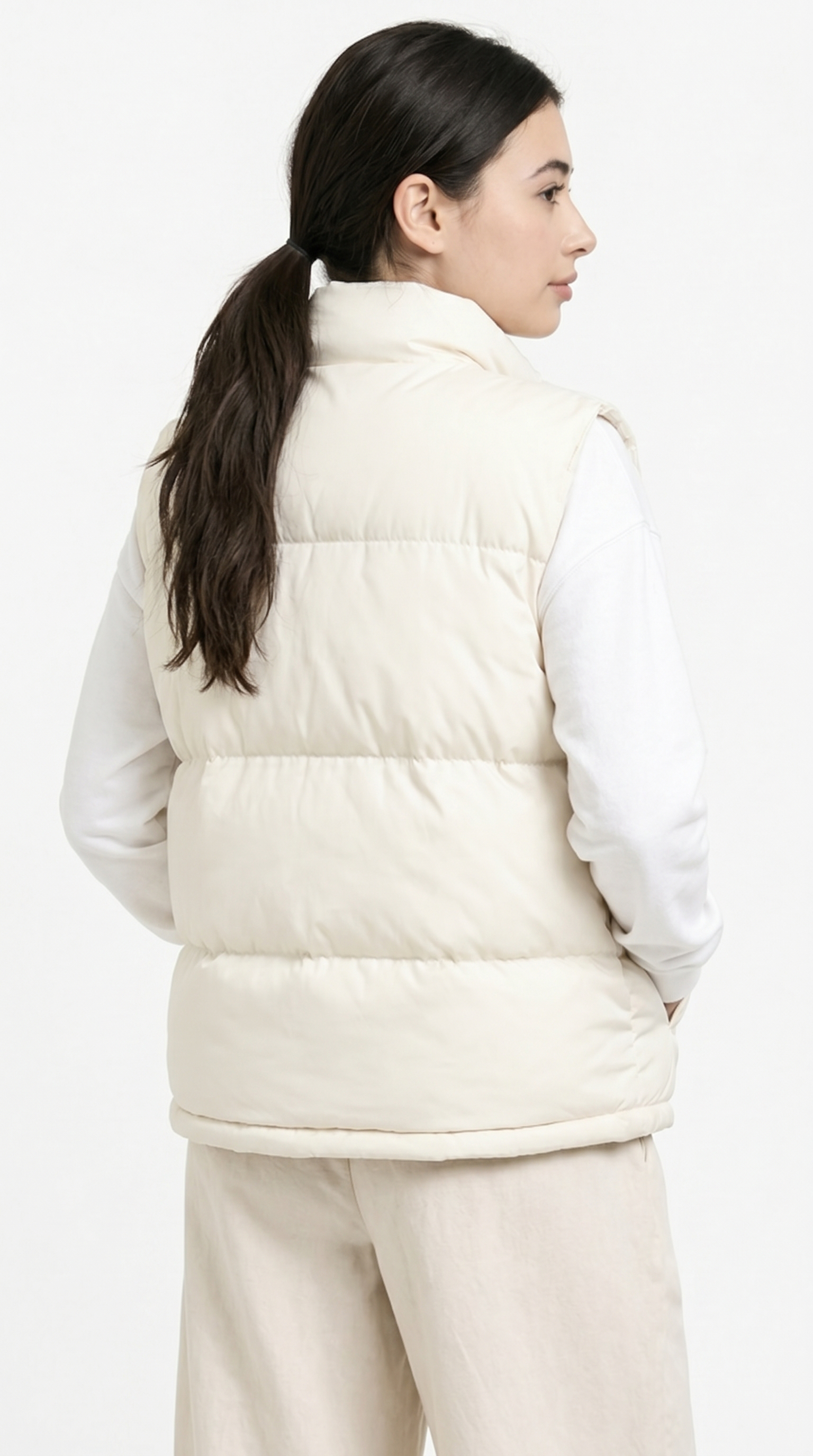 girl from back view wearing a white puffer vest over a white shirt on a white background from Meleche Fashion USA or Meléche (short as (Mé))