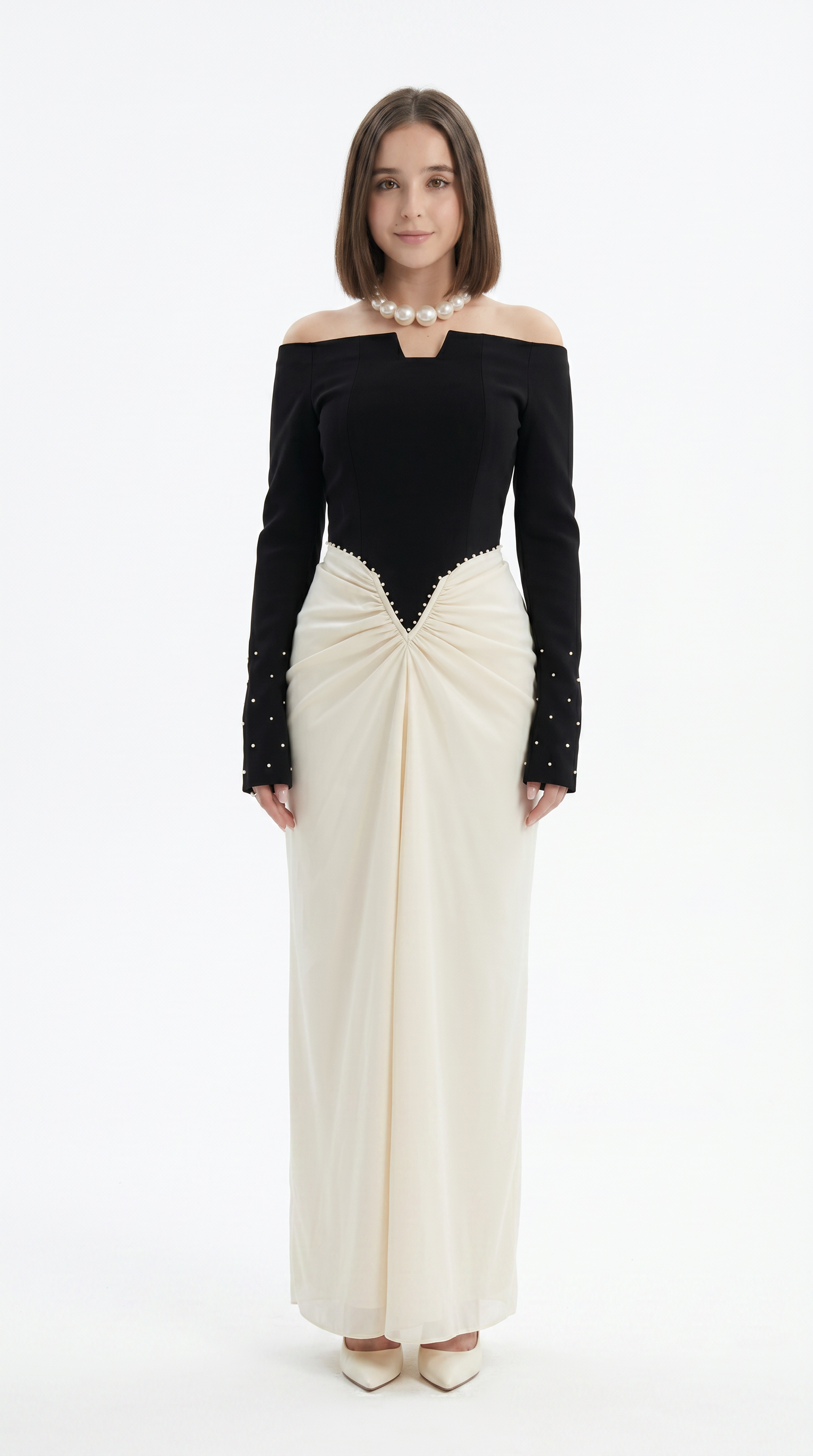 Woman wearing a black and white off-shoulder dress on a white background