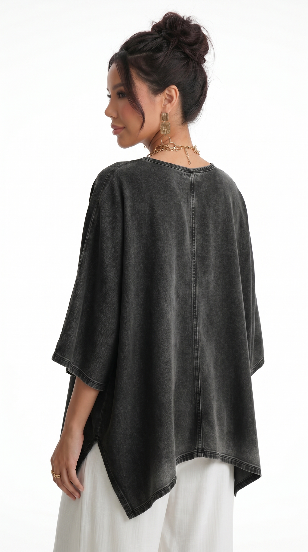 Woman wearing a black denim poncho over a white outfit on a white background, from Meleche Fashion USA or Meléche (short as (Mé))