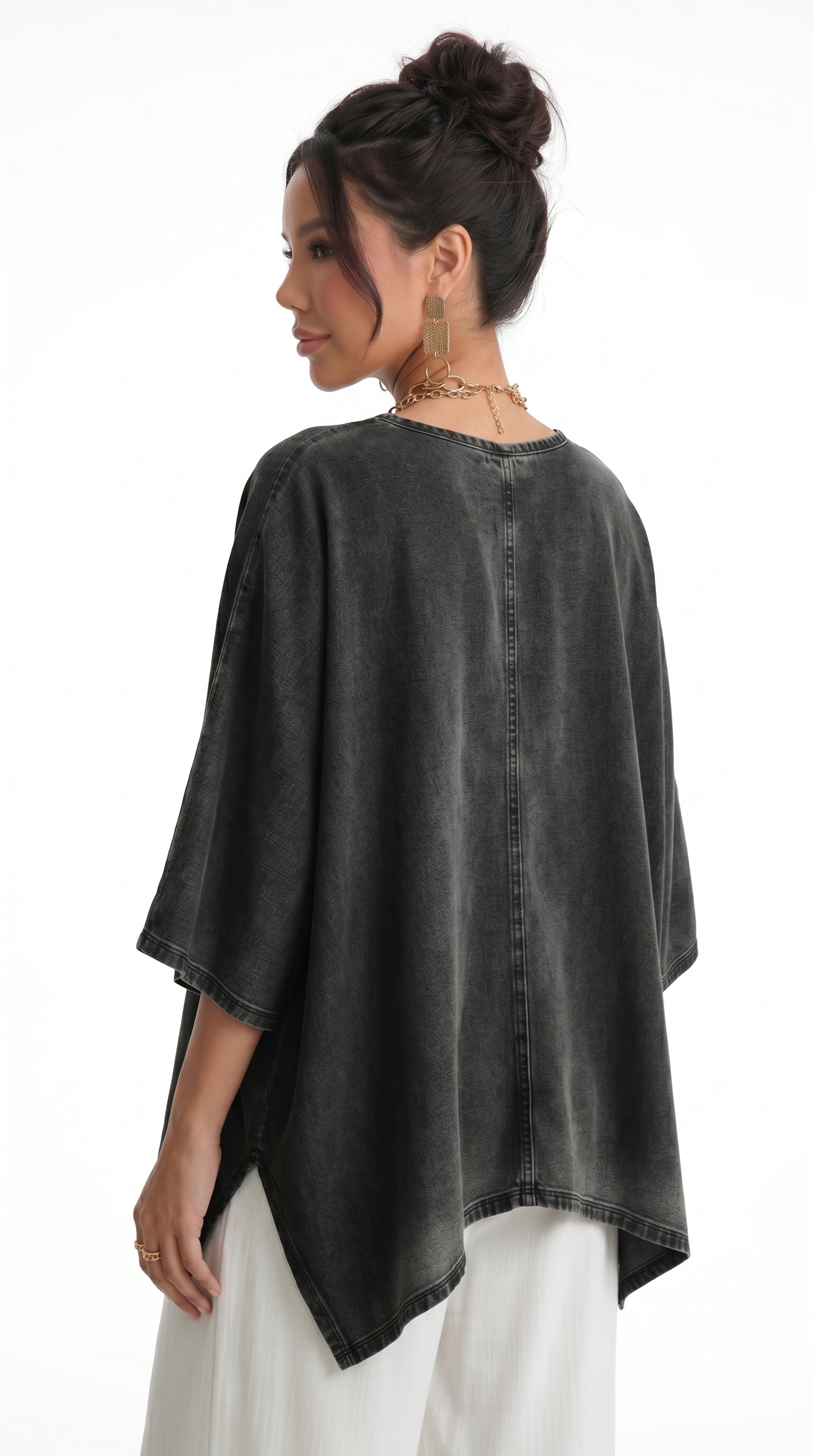 Woman wearing a black denim poncho over a white outfit on a white background, from Meleche Fashion USA or Meléche (short as (Mé))