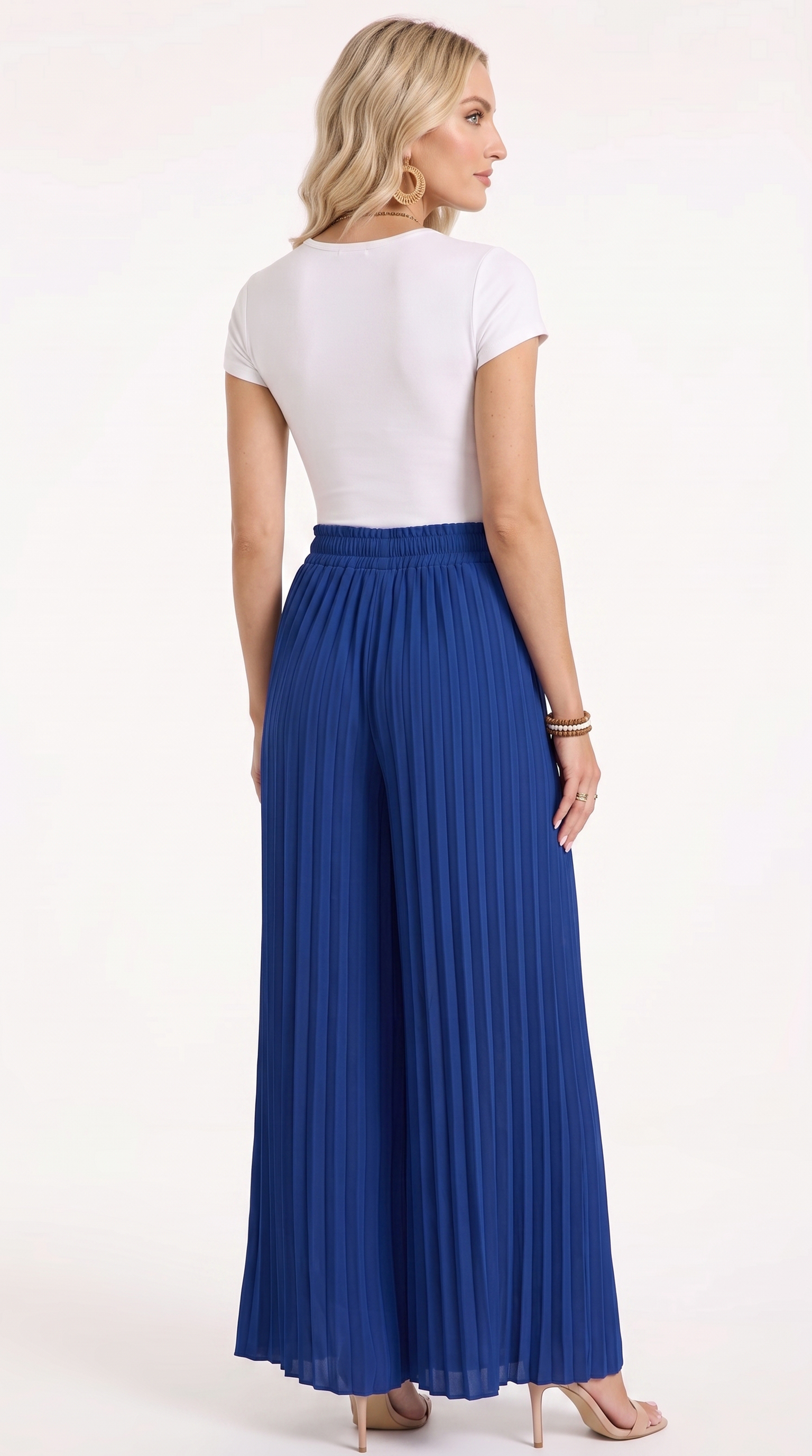 A woman shown from the back wearing a white short-sleeve top and a high-waisted, wide-leg pleated maxi skirt in royal blue, standing against a plain white studio background, from Meleche Fashion USA or Meléche (short as (Mé))
