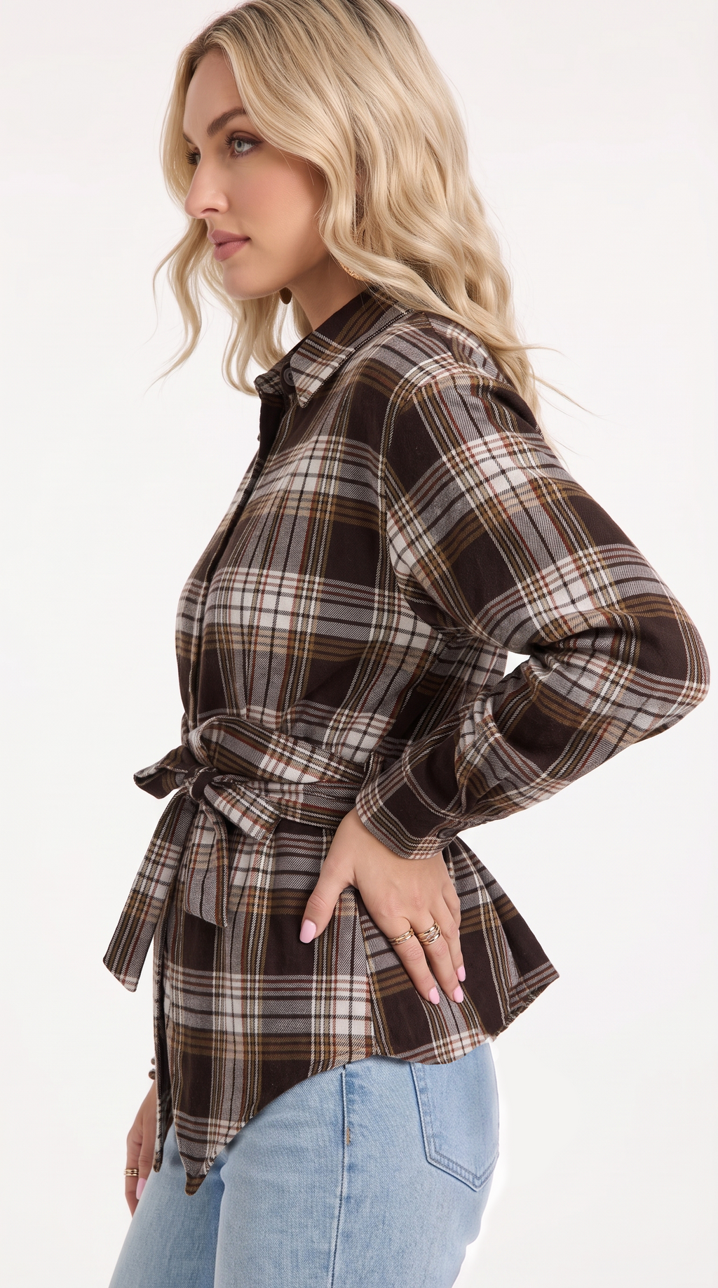 A woman wearing a brown and beige plaid long-sleeve button-up shirt with a tie waist, paired with light blue jeans, shown from a side profile against a white background, from Meleche Fashion USA or Meléche (short as (Mé))