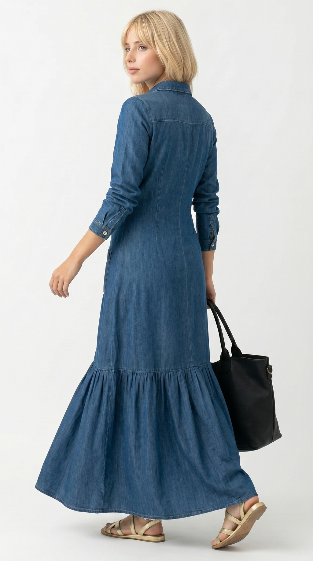 Woman wearing a long blue dress holding a black handbag on a white background, Loos dress from Meleche Fashion USA or Meléche (short as (Mé))