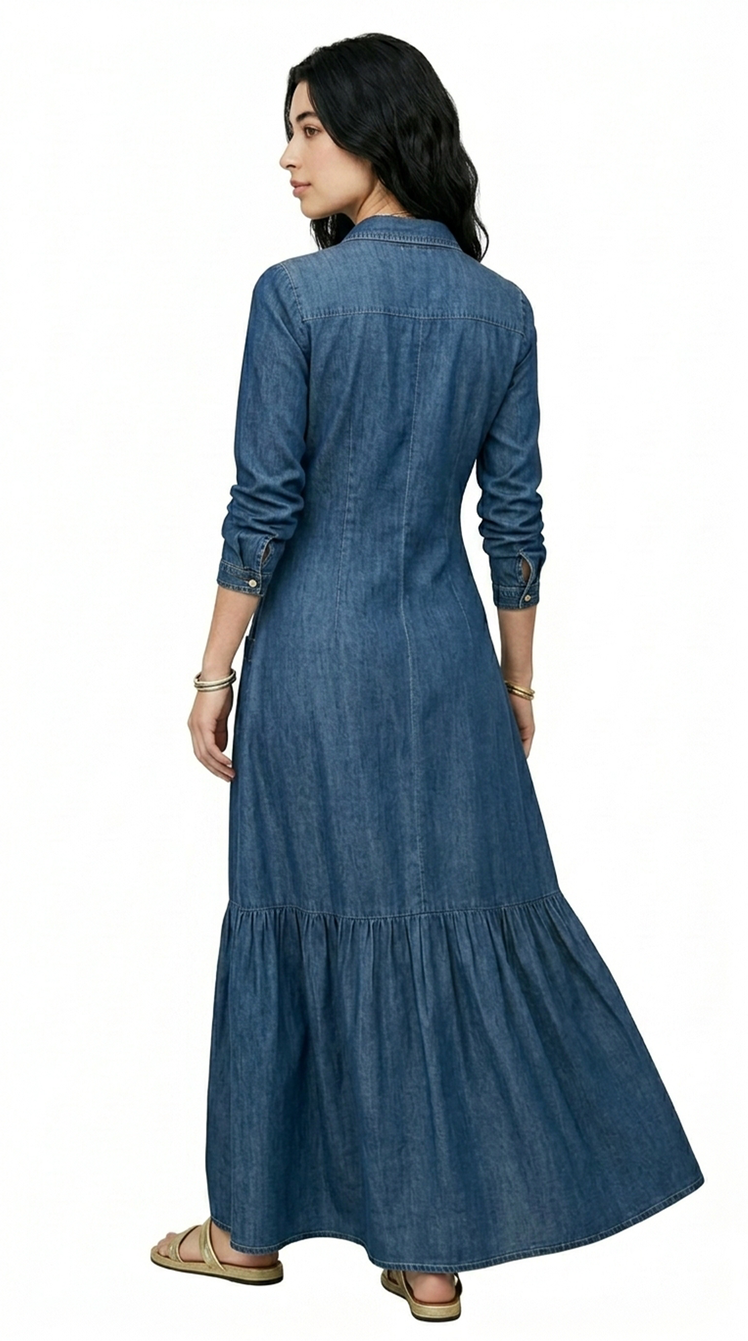 Woman wearing a dark gray tiered dress on a white background