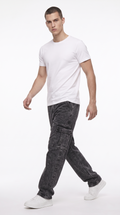 A man modeling a white crew-neck t-shirt and dark gray washed cargo jeans with white sneakers, captured in a side-profile walking pose against a clean white studio background, from Meleche Fashion USA or Meléche (short as (Mé))