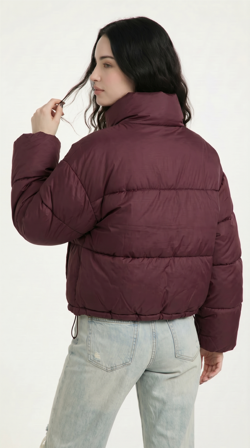 Woman wearing a burgundy puffer jacket on a white background from Meleche USA or Meléche (short as (Mé))