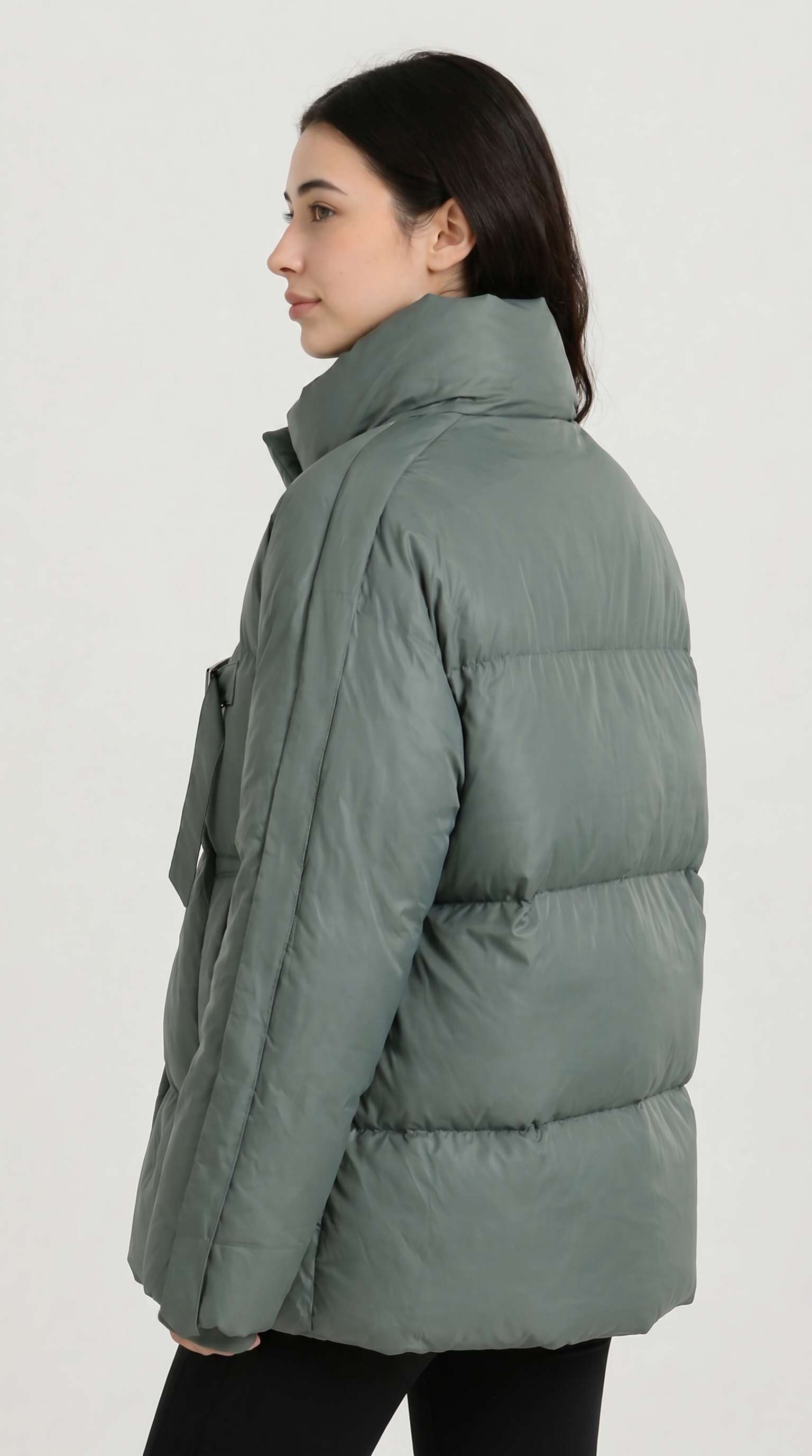 Woman wearing a green puffer jacket on a white background from Meleche USA or Meléche (short as (Mé))