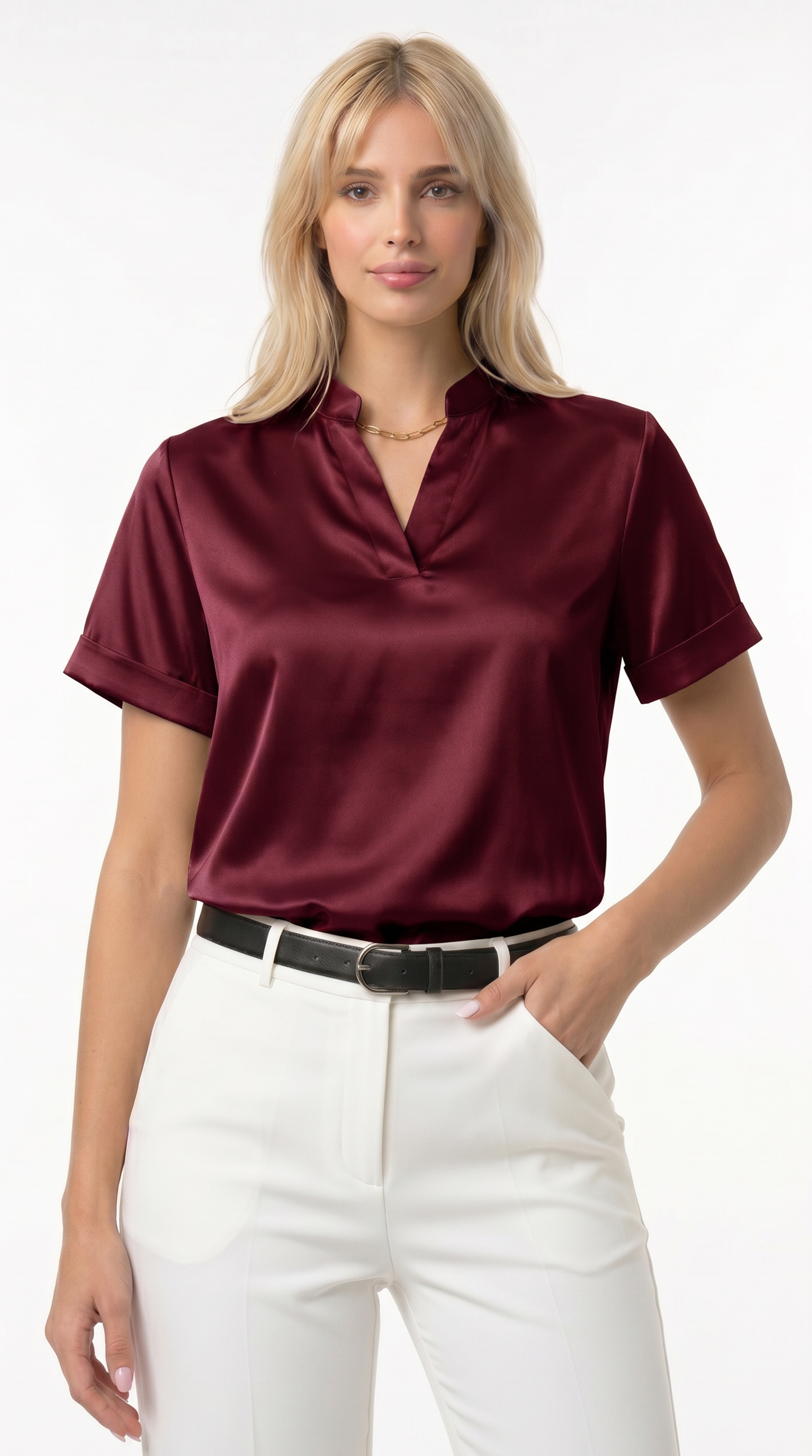 Woman wearing a burgundy satin blouse and white pants on a white background