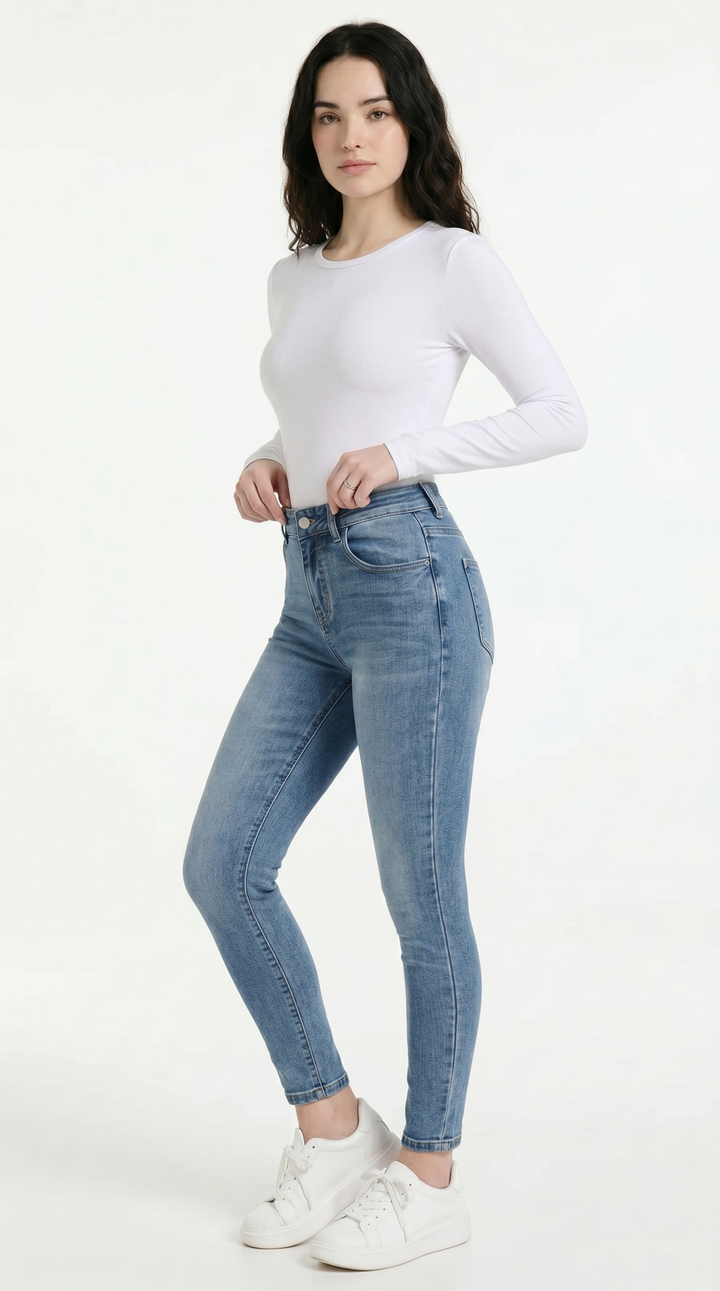 Woman wearing light blue jeans and a white top on a white background, High Stretch Sexy Skinny jeans from Meleche Fashion USA or Meléche (short as (Mé))