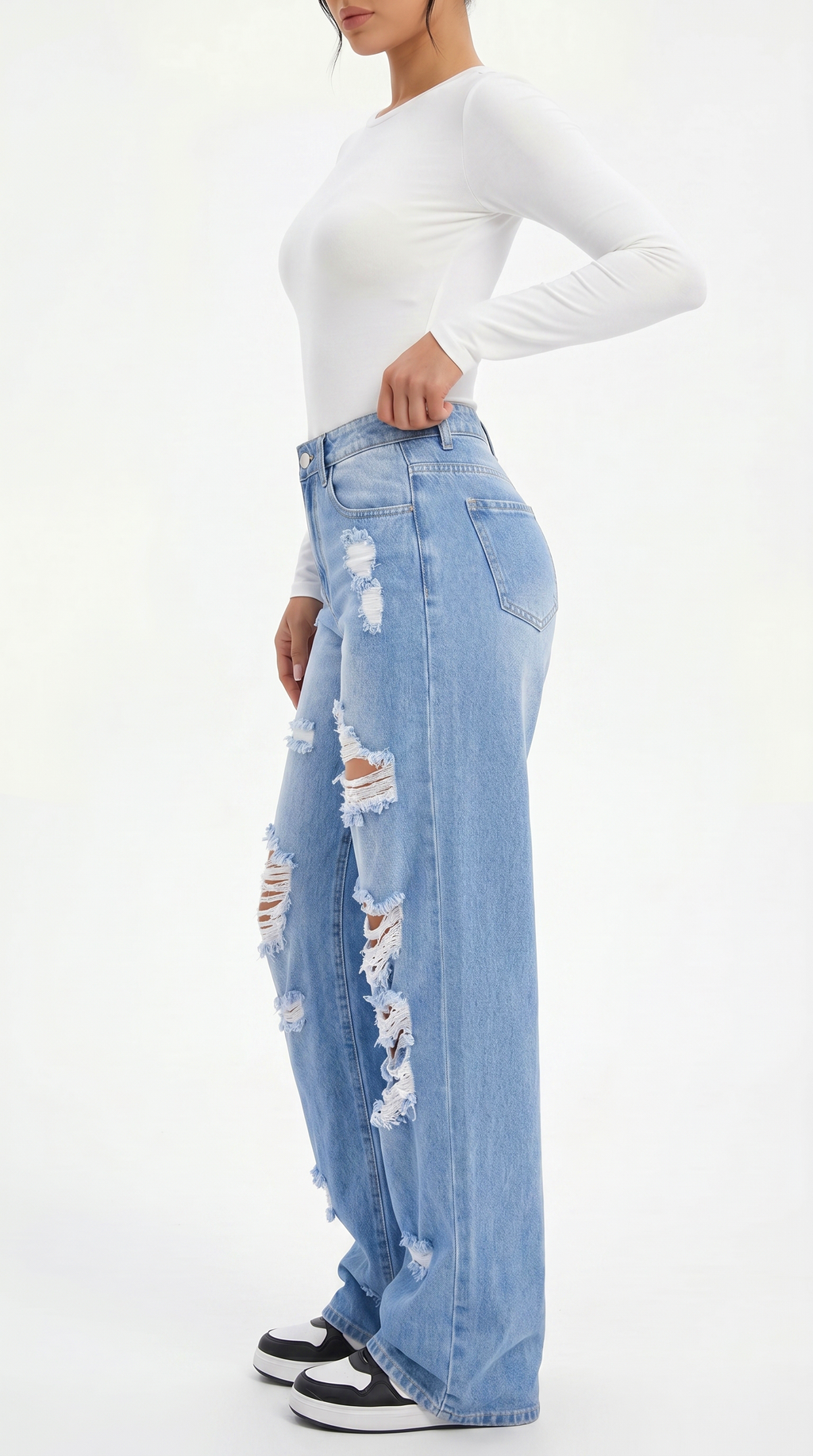 Person wearing a white long-sleeve top and light blue ripped jeans on a white background, Wide-leg jeans from Meleche Fashion USA or Meléche (short as (Mé))