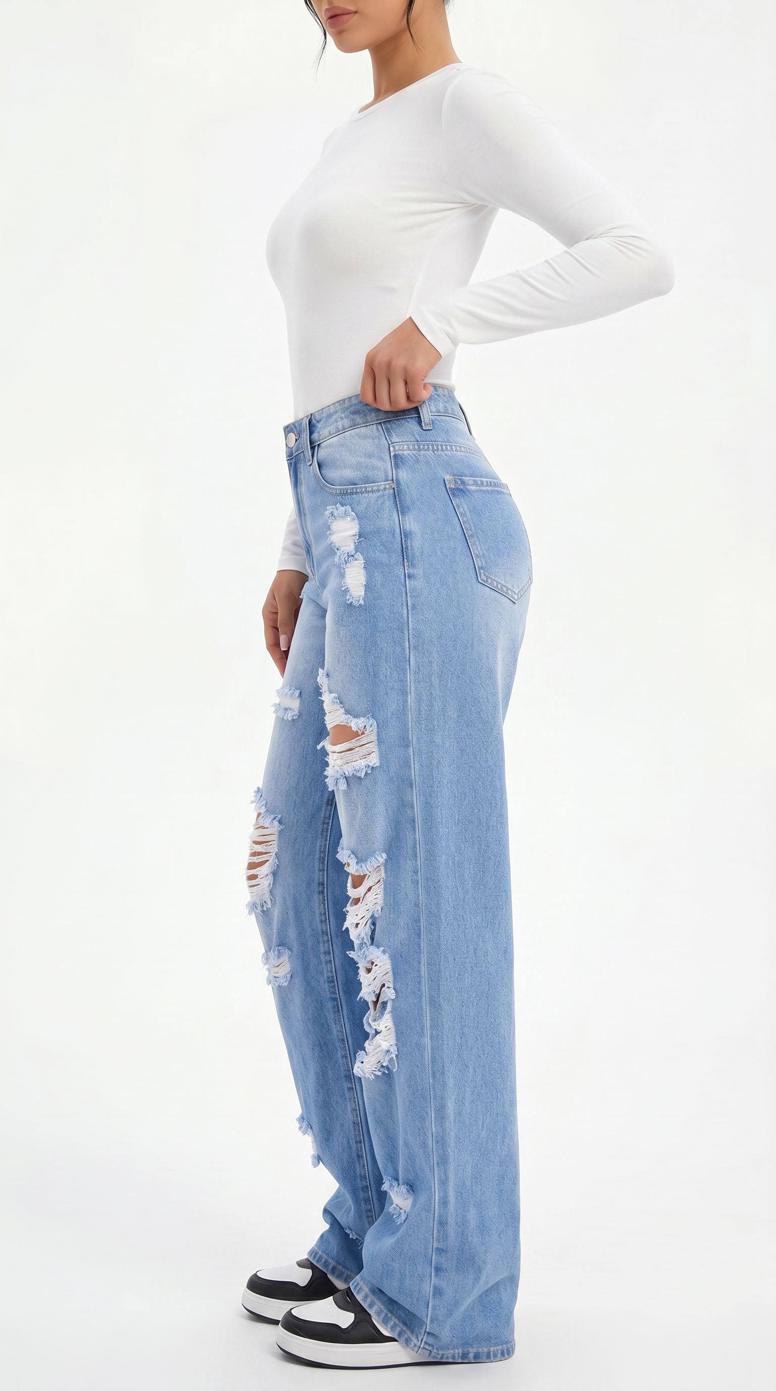 Person wearing a white long-sleeve top and light blue ripped jeans on a white background, Wide-leg jeans from Meleche Fashion USA or Meléche (short as (Mé))