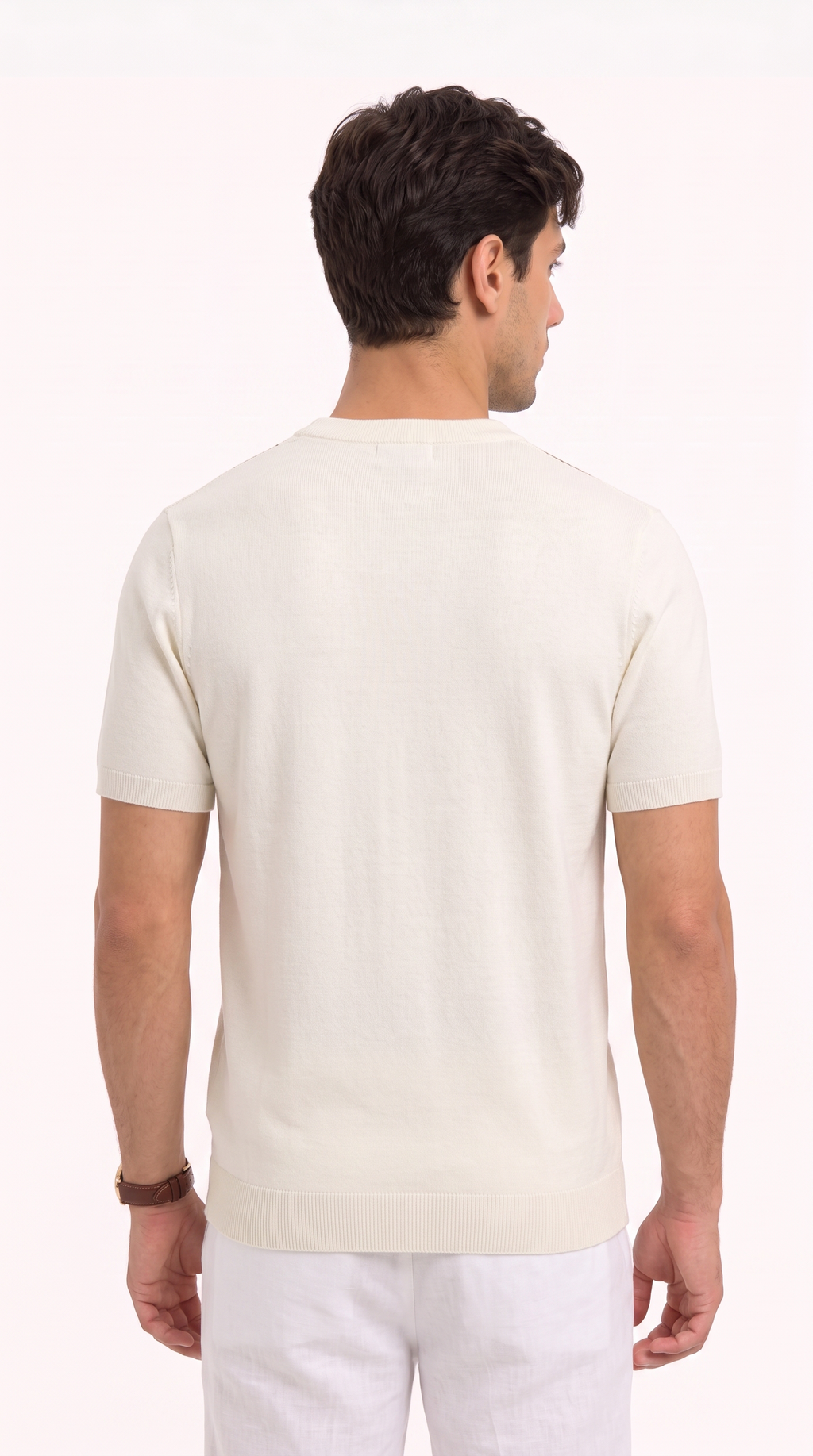 A man viewed from the back wearing a cream-colored short-sleeve knit shirt and white trousers, set against a plain white studio background, from Meleche Fashion USA or Meléche (short as (Mé))