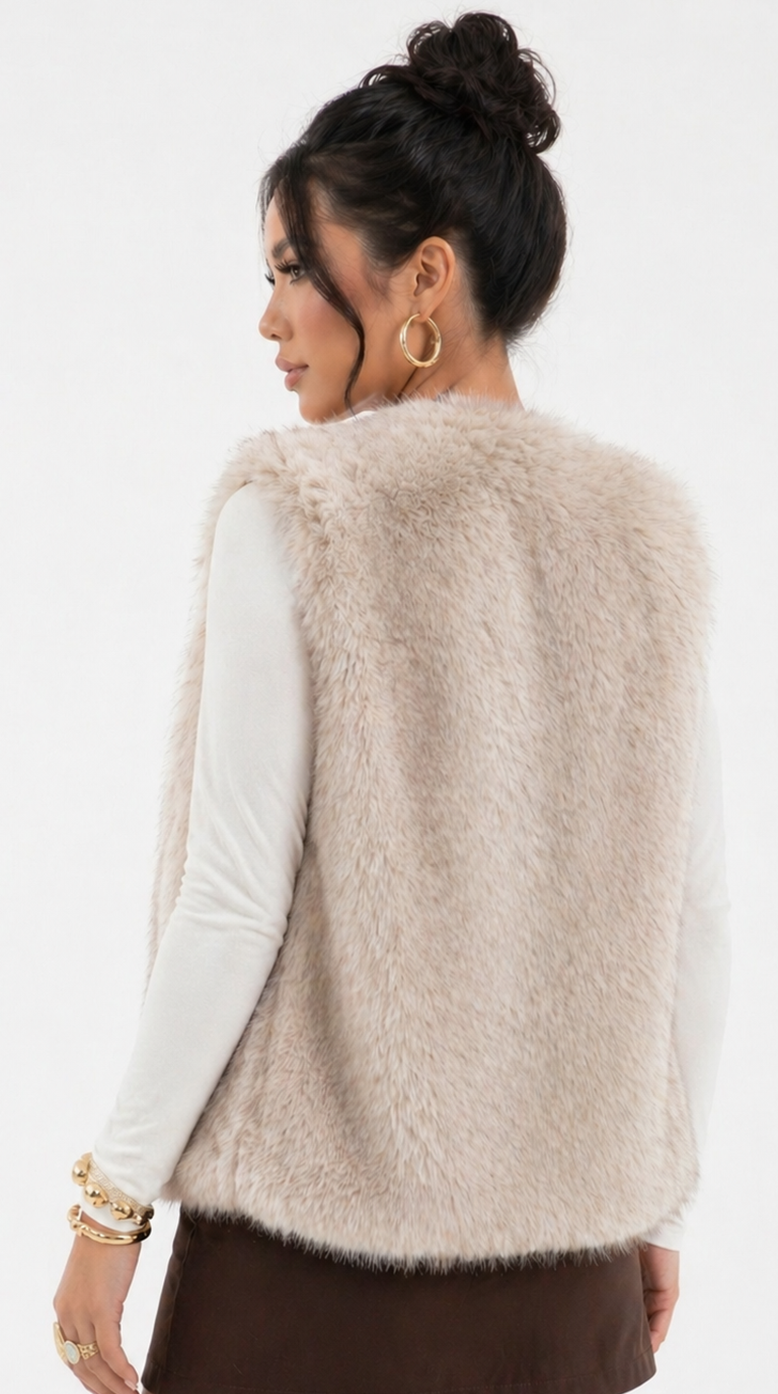 Woman wearing a beige fleece vest over a black turtleneck on a white background from Meleche Fashion USA or Meléche (short as (Mé))