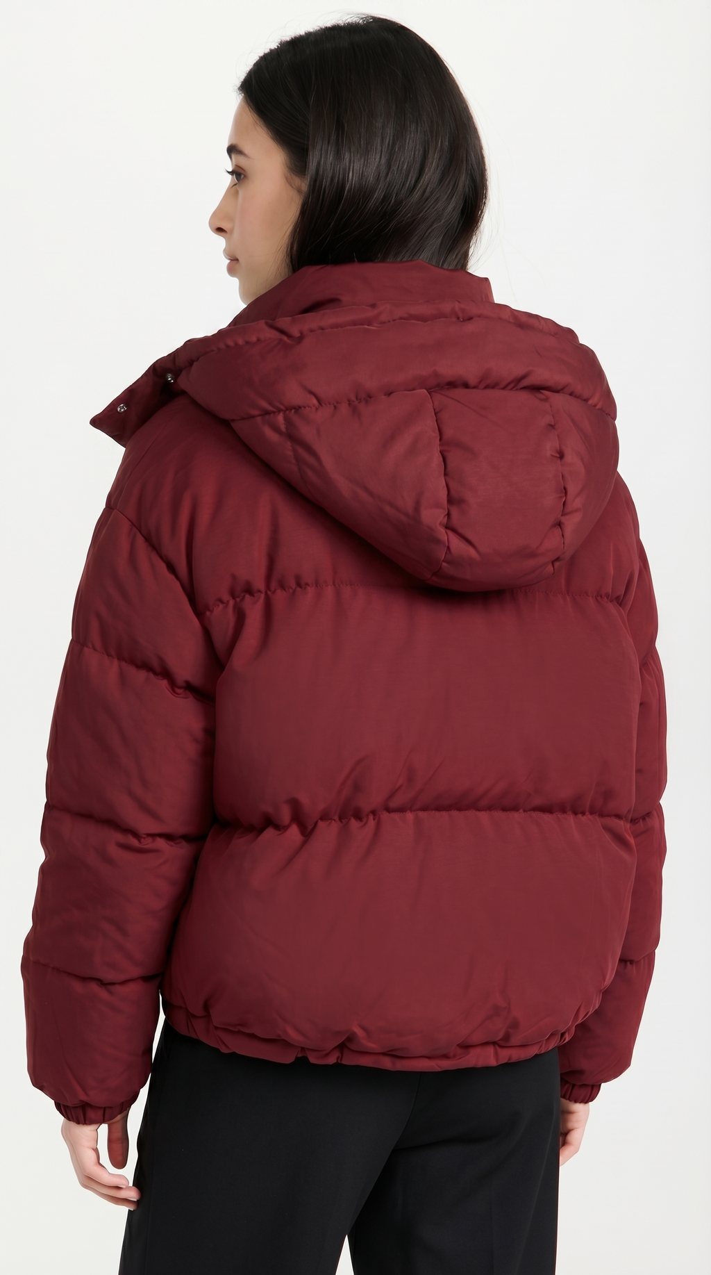 Person wearing a red puffer jacket on a white background from Meleche USA or Meléche (short as (Mé))