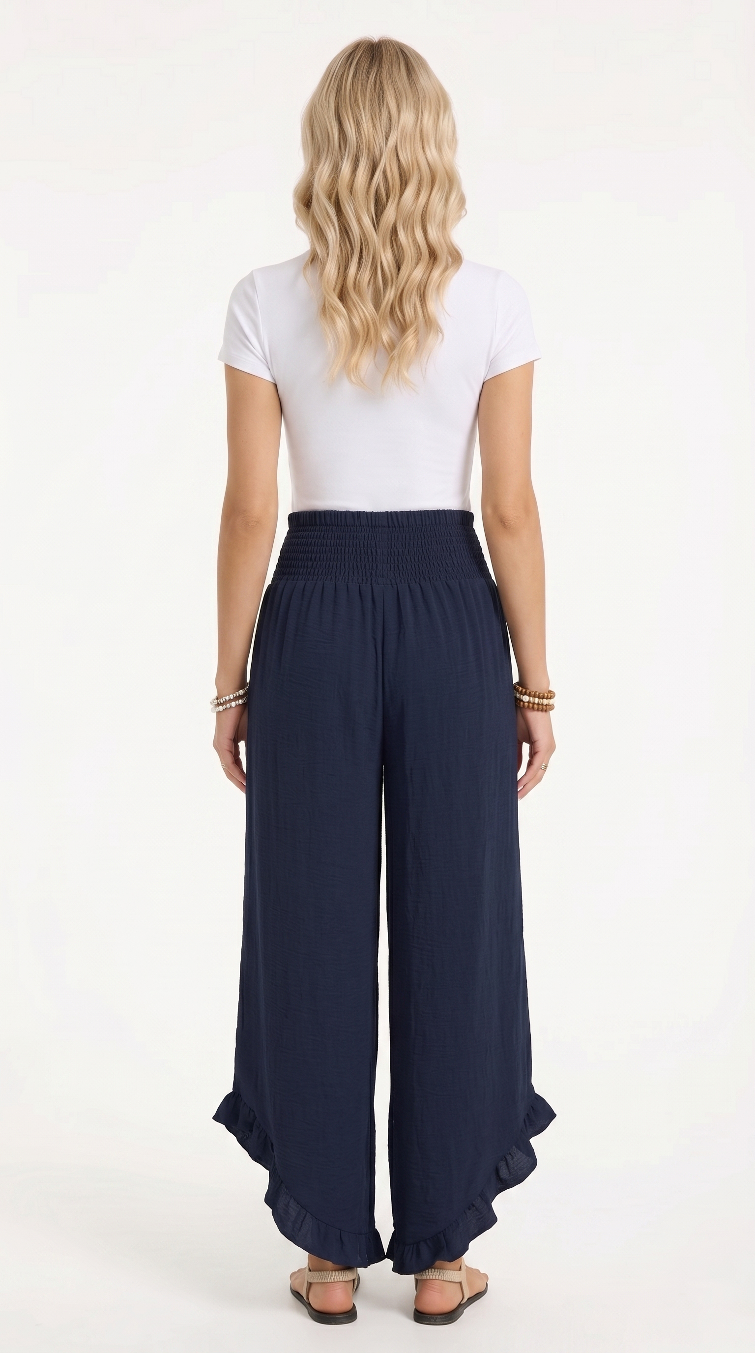 Person wearing navy wide-leg pants and a white top on a white background, from Meleche Fashion USA or Meléche (short as (Mé))