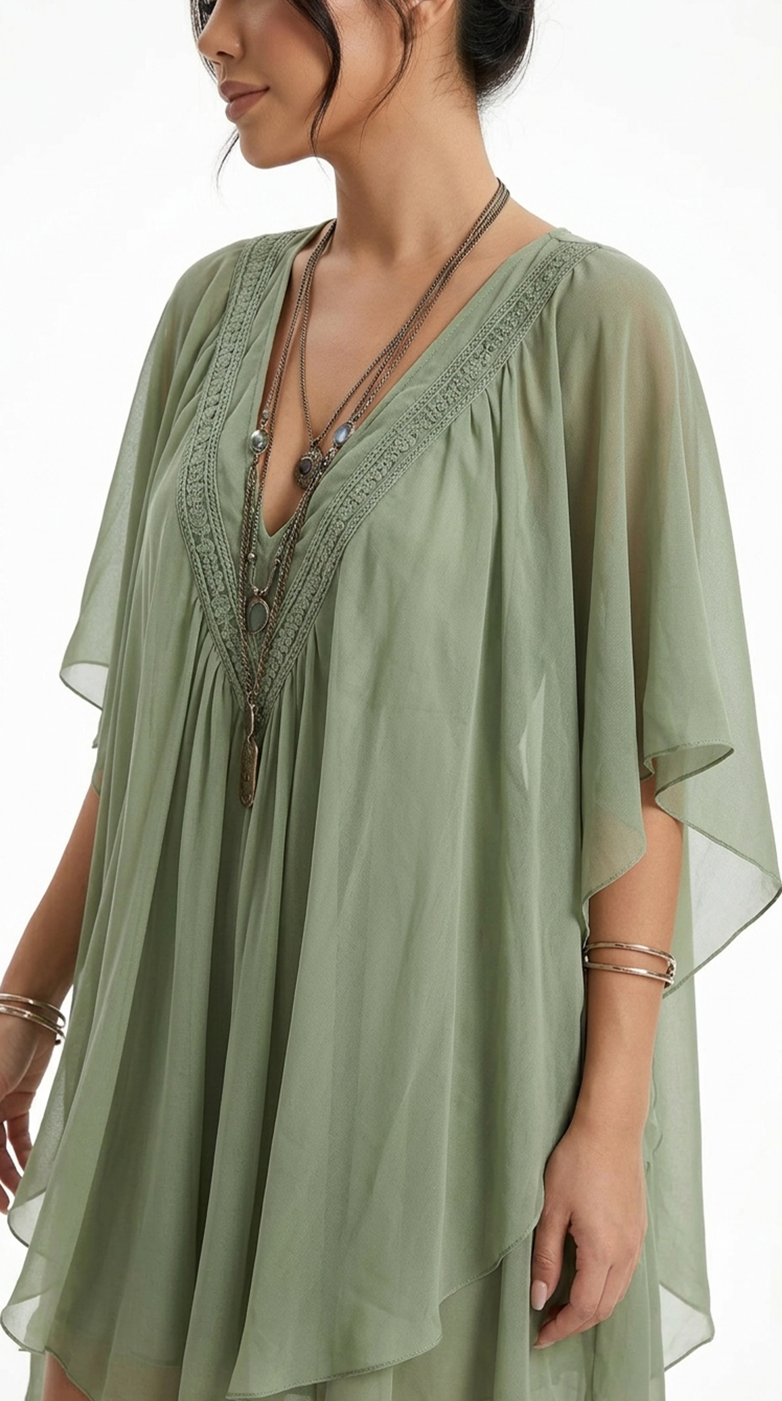 Woman wearing a pink long-sleeve top and white pants on a white background