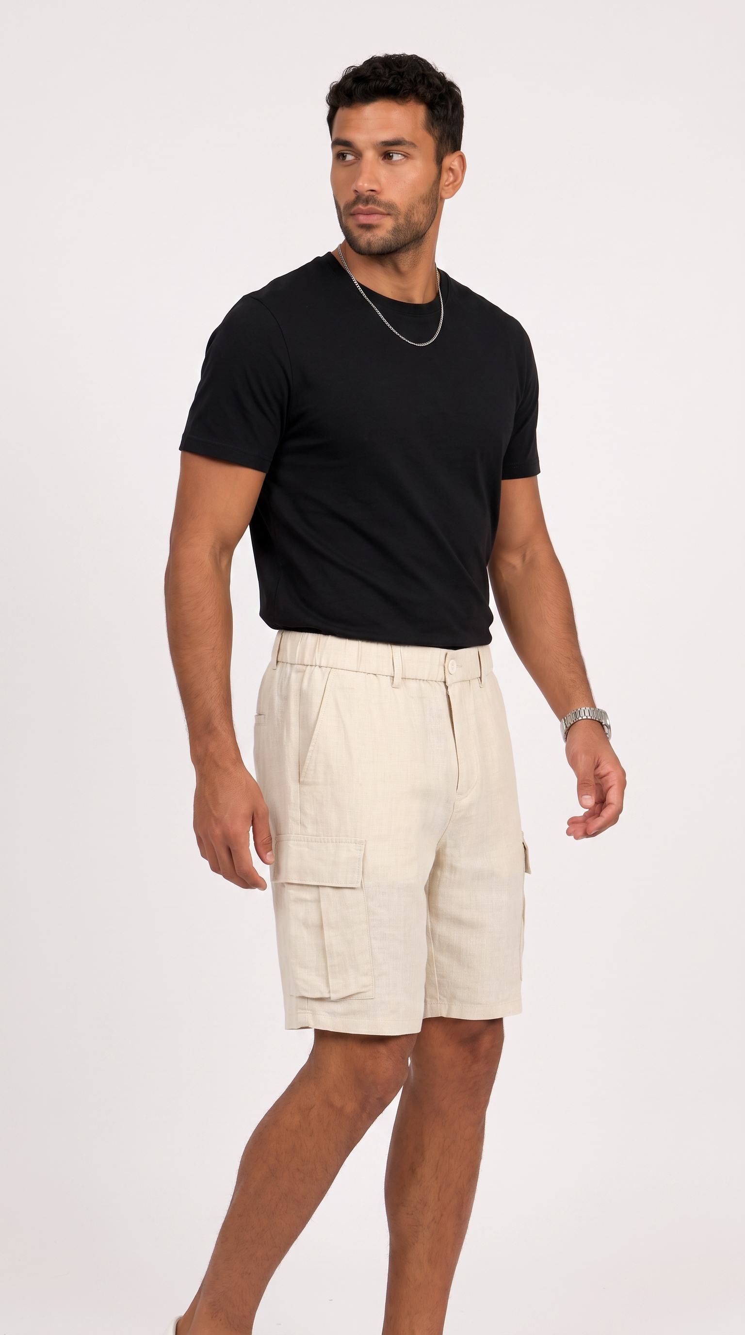A man modeling a black short-sleeve crewneck t-shirt and light beige cargo shorts against a plain white studio background, from Meleche Fashion USA or Meléche (short as (Mé))