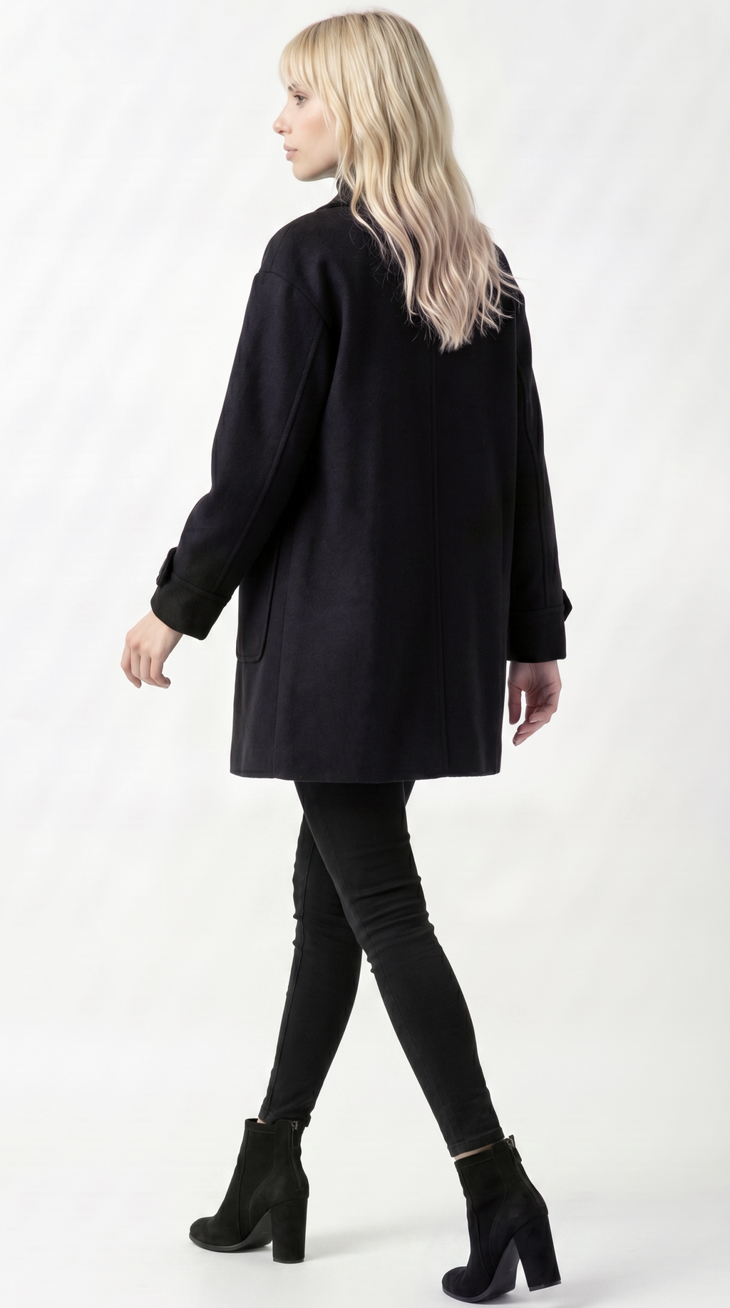 Woman wearing a black coat, black leggings, and black boots on a white background from Meleche or Meléche USA (short as (Mé))