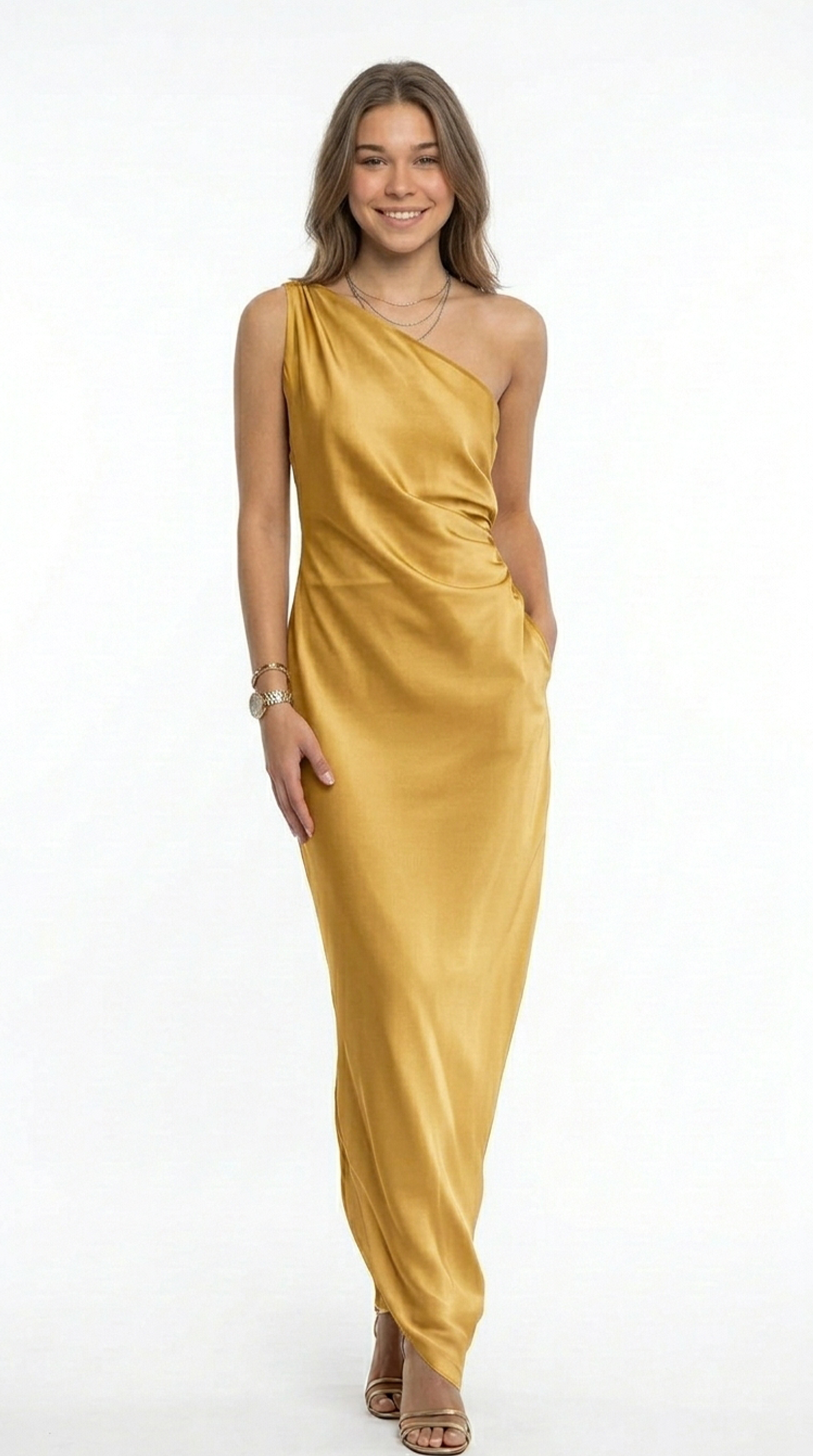 Woman wearing a green caftan with a plain background