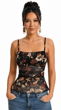 Woman wearing a floral top and jeans on a white background, from Meleche Fashion USA or Meléche (short as (Mé))