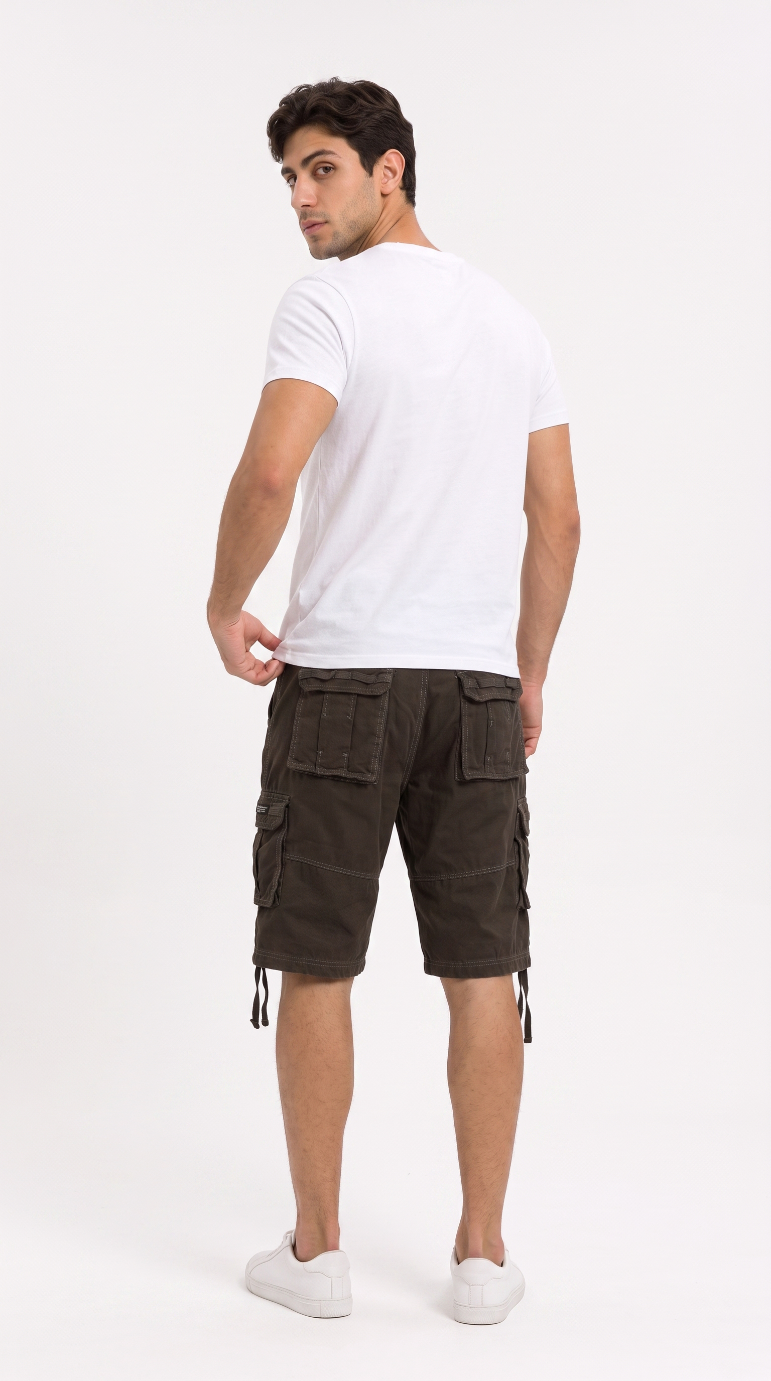 A man wearing dark brown cargo shorts and a white t-shirt, shown from a rear three-quarter view against a plain white studio background, from Meleche Fashion USA or Meléche (short as (Mé))