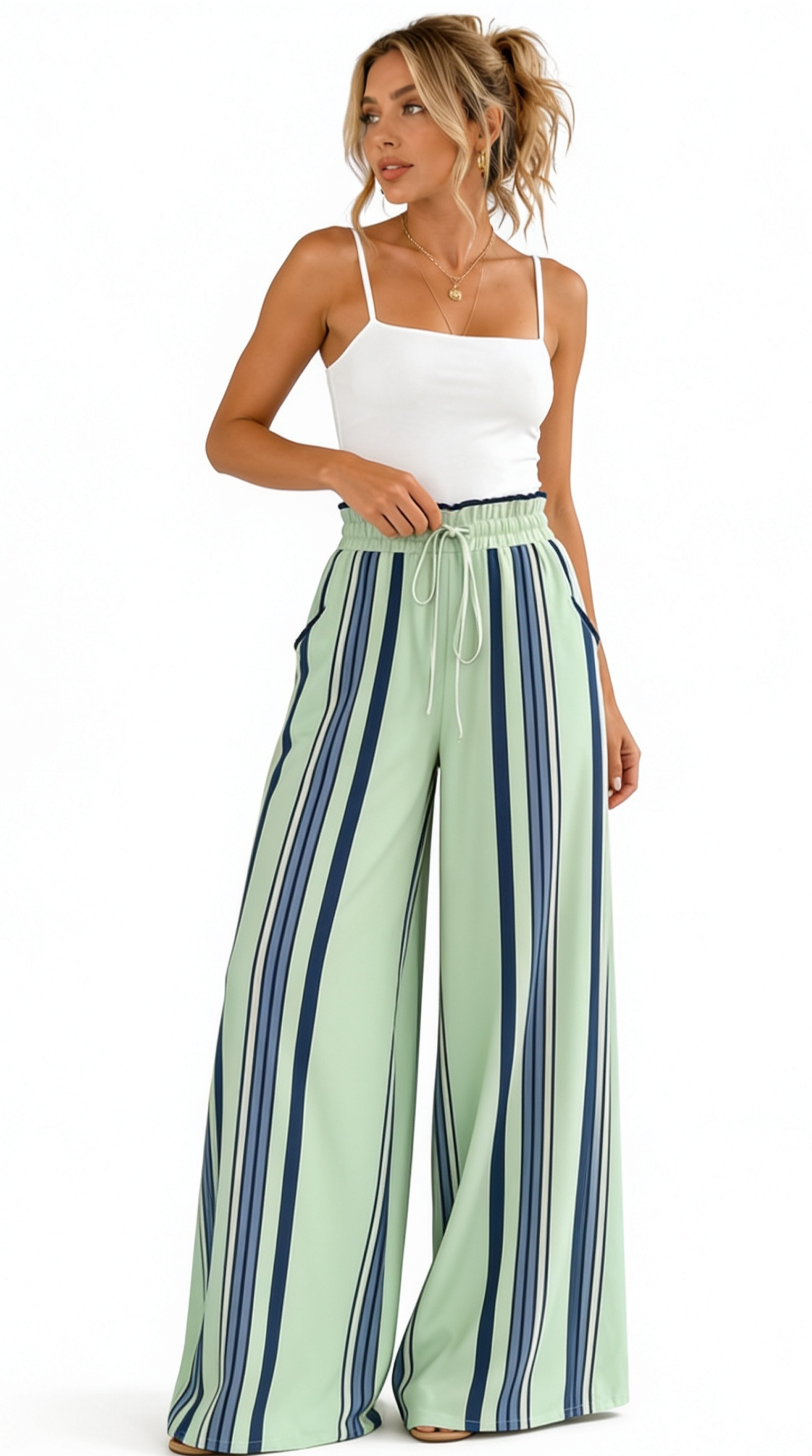 Woman wearing a white top and green and blue striped pants on a white background