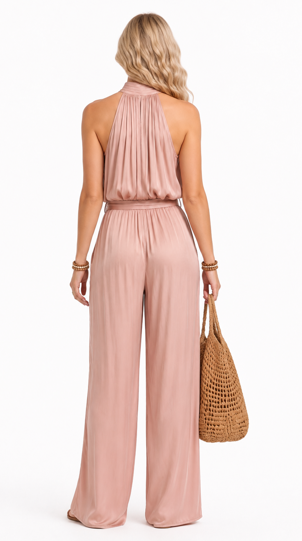 Woman wearing a pink jumpsuit holding a straw bag on a white background, from Meleche Fashion USA or Meléche (short as (Mé))
