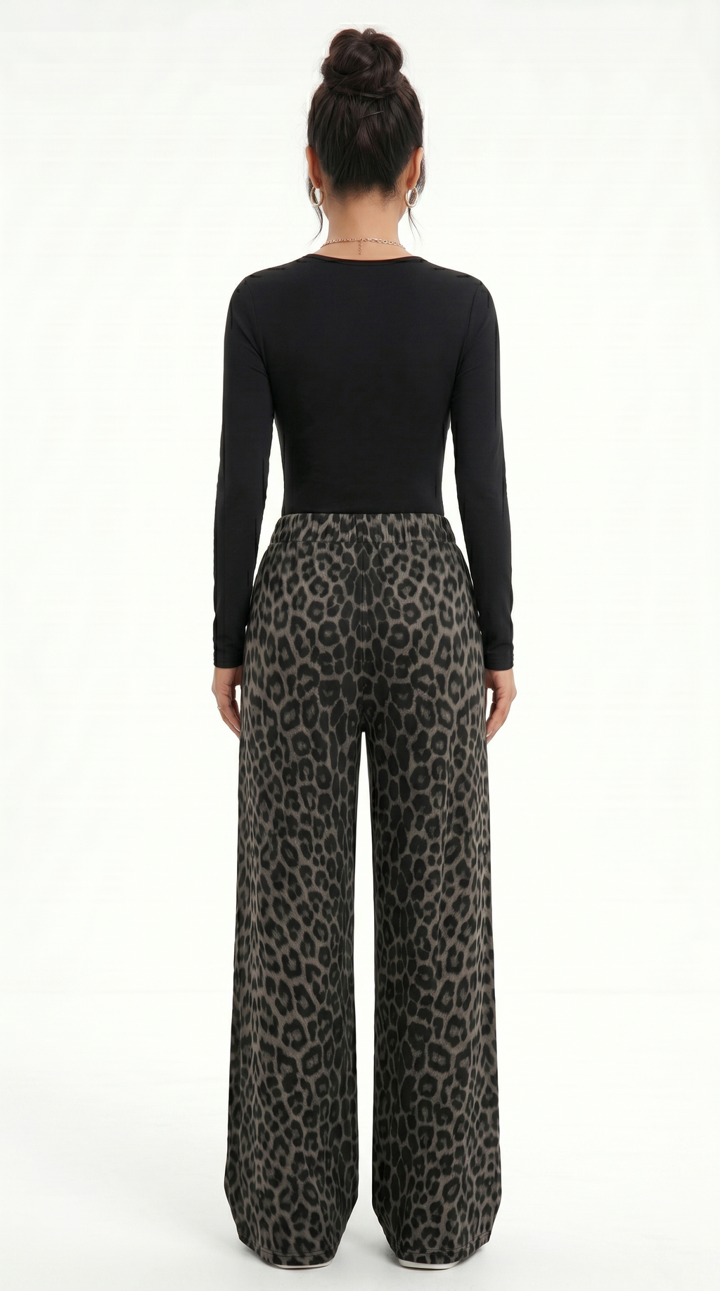 Person wearing a black long-sleeve top and leopard print pants on a white background, sexy pants from Meleche Fashion USA or Meléche (short as (Mé))