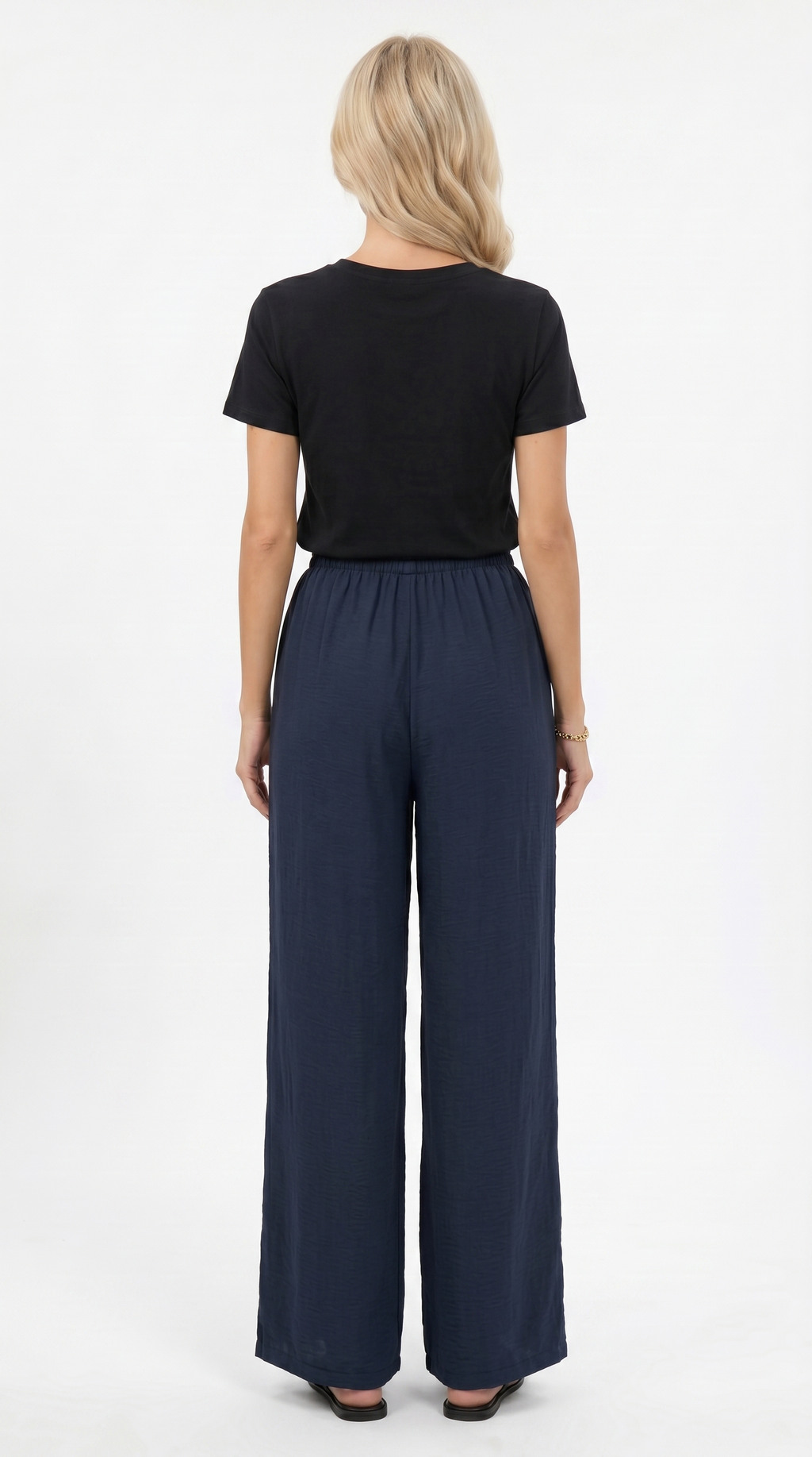 Woman wearing a black top and navy wide-leg pants on a white background, sexy loss pants from Meleche Fashion USA or Meléche (short as (Mé))
