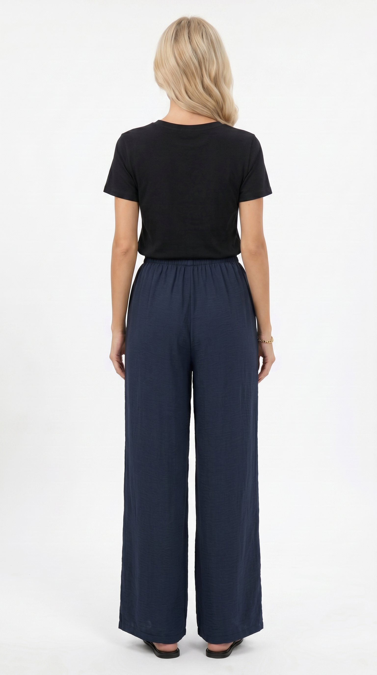 Woman wearing a black top and navy wide-leg pants on a white background, sexy loss pants from Meleche Fashion USA or Meléche (short as (Mé))