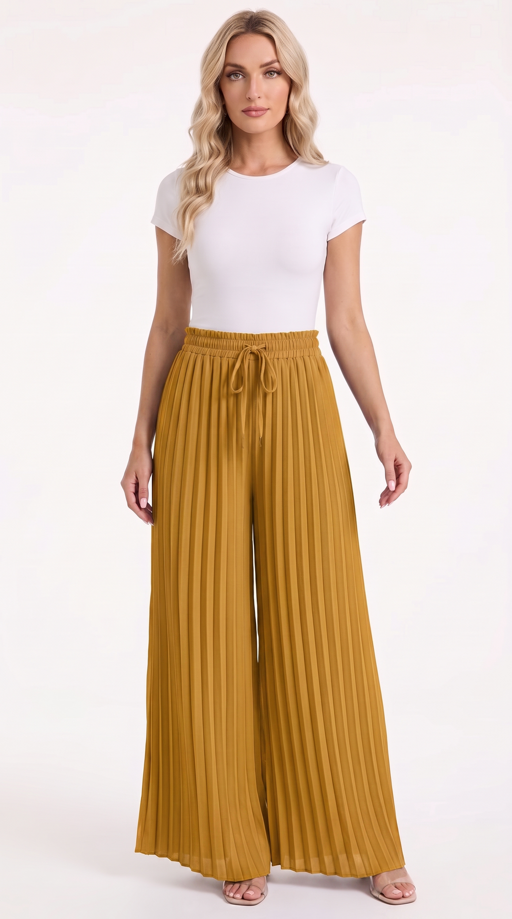 A woman modeling a white short-sleeve crewneck top and high-waisted, wide-leg pleated trousers in a rich mustard yellow color, paired with neutral sandals, against a plain white studio background, from Meleche Fashion USA or Meléche (short as (Mé))