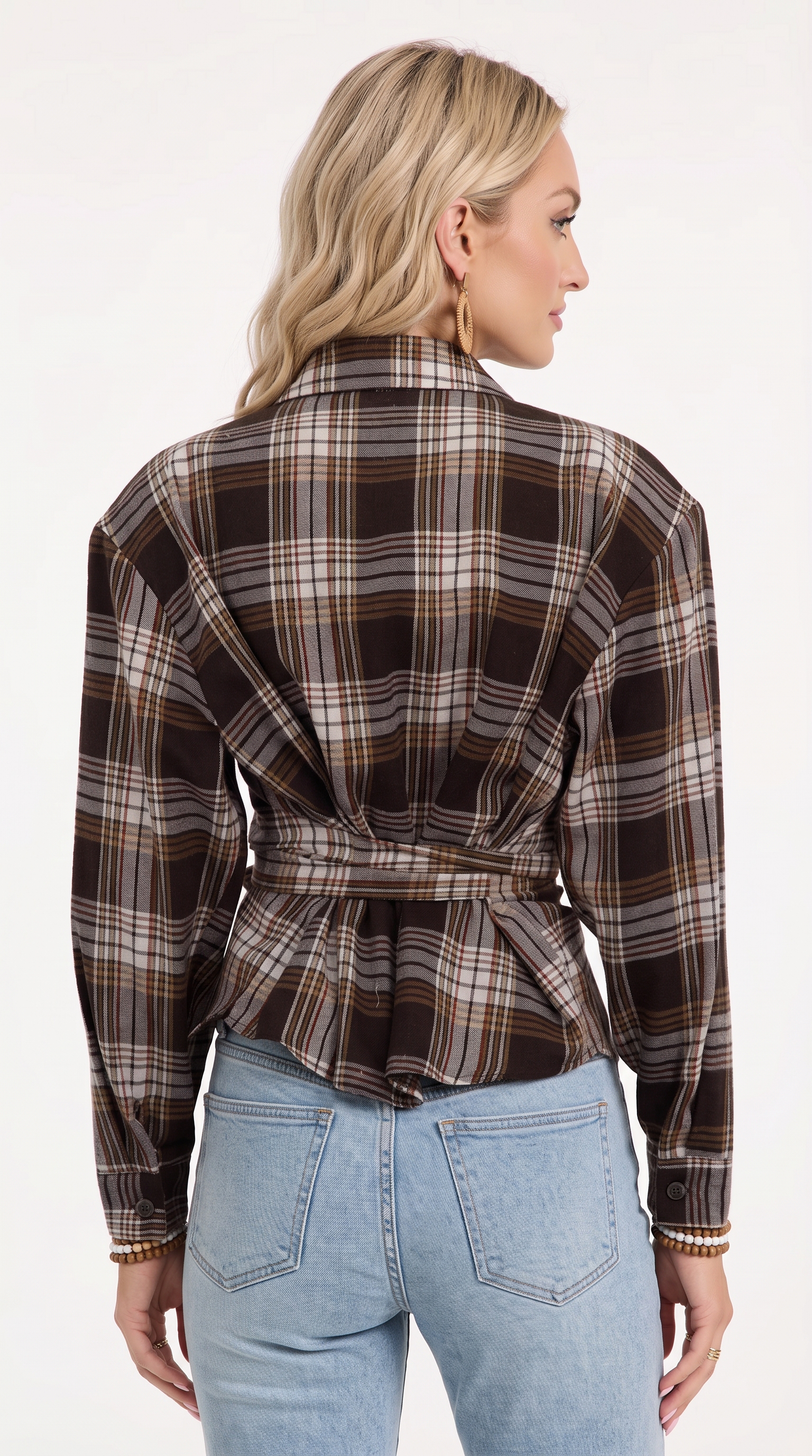 A woman shown from the back wearing a long-sleeve plaid wrap-style blouse in dark brown, beige, and black, paired with light blue jeans, against a plain white studio background, from Meleche Fashion USA or Meléche (short as (Mé))