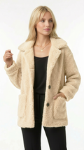 Woman wearing a beige sherpa coat on a white background from Meleche Fashion USA or Meléche (short as (Mé))