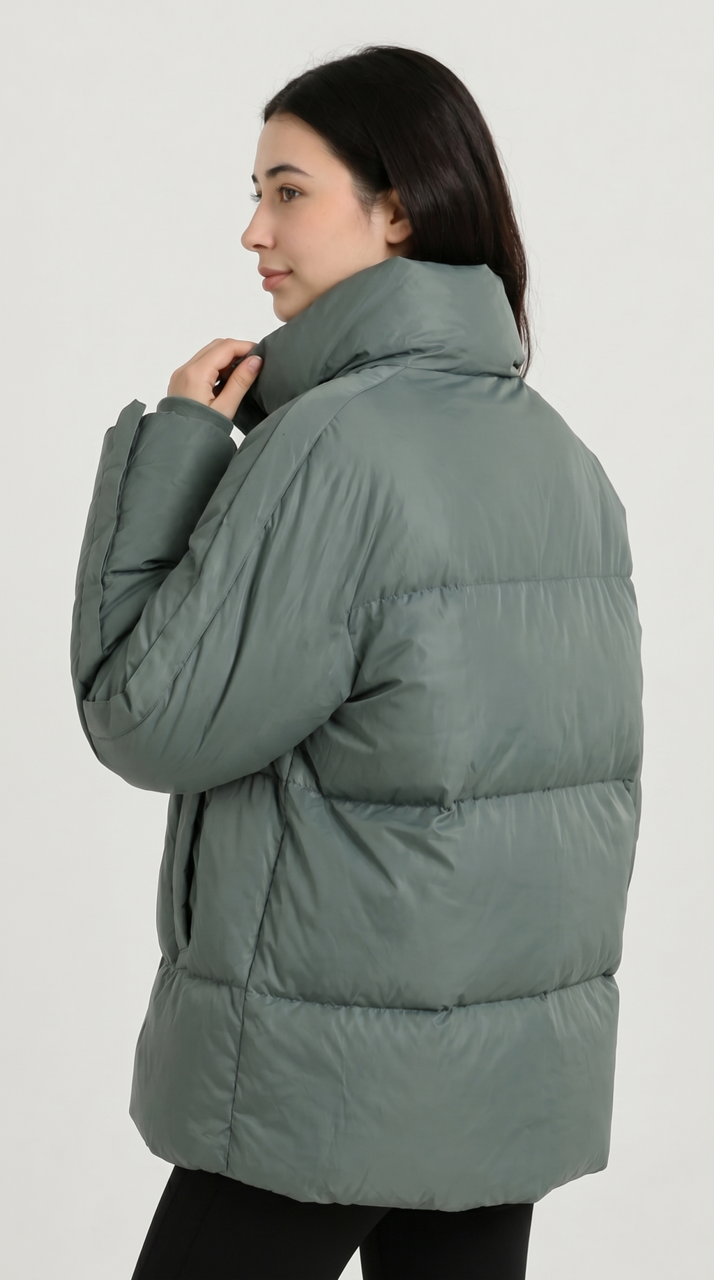 Person wearing a green puffer jacket on a white background from Meleche or Meléche USA (short as (Mé))