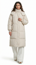 Woman wearing a long beige puffer coat on a white background from Meleche Fashion USA or Meléche (short as (Mé))