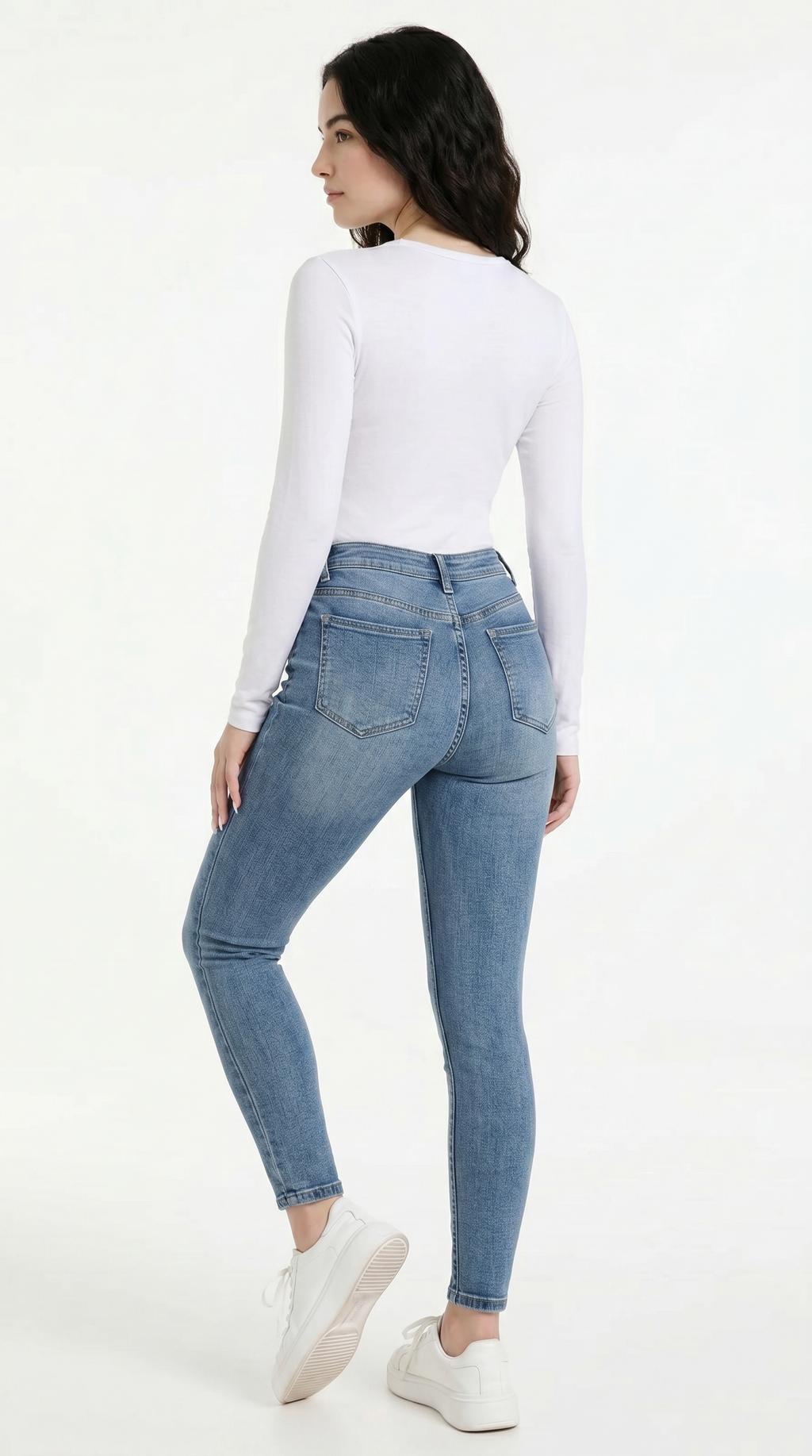 Woman wearing light blue jeans and a white top on a white background, High Stretch Sexy Skinny jeans from Meleche Fashion USA or Meléche (short as (Mé))