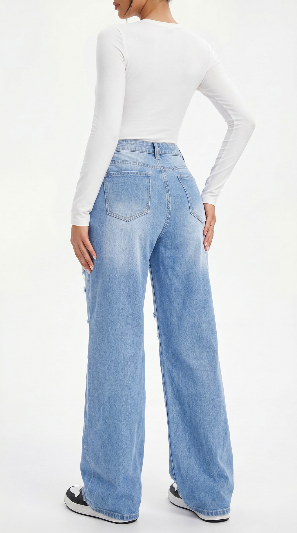Person wearing light blue jeans and a white long-sleeve top on a white background, Wide-leg jeans from Meleche Fashion USA or Meléche (short as (Mé))