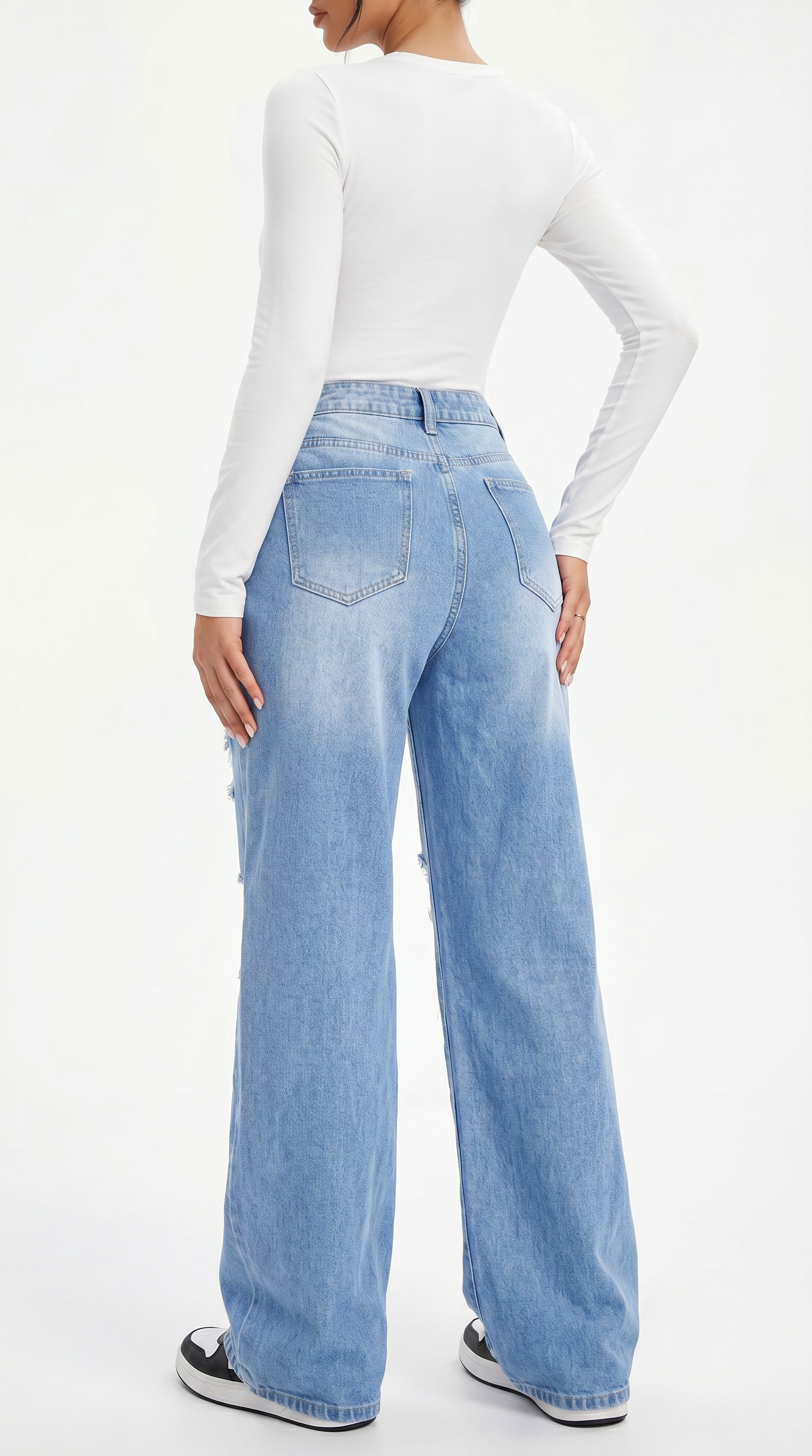 Person wearing light blue jeans and a white long-sleeve top on a white background, Wide-leg jeans from Meleche Fashion USA or Meléche (short as (Mé))