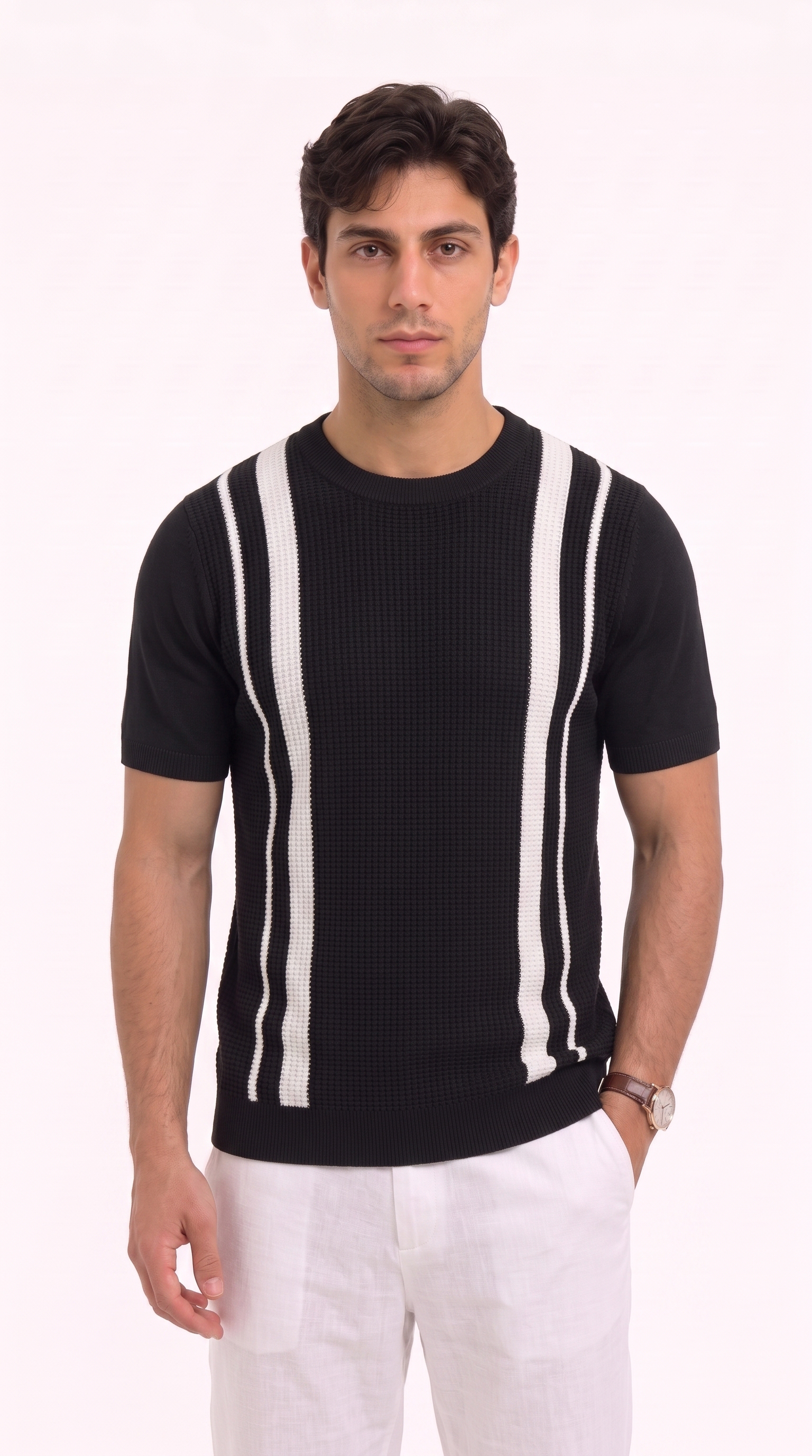 A man wearing a black short-sleeve knit sweater with vertical white stripes on the chest, paired with white trousers, standing against a plain white background, from Meleche Fashion USA or Meléche (short as (Mé))