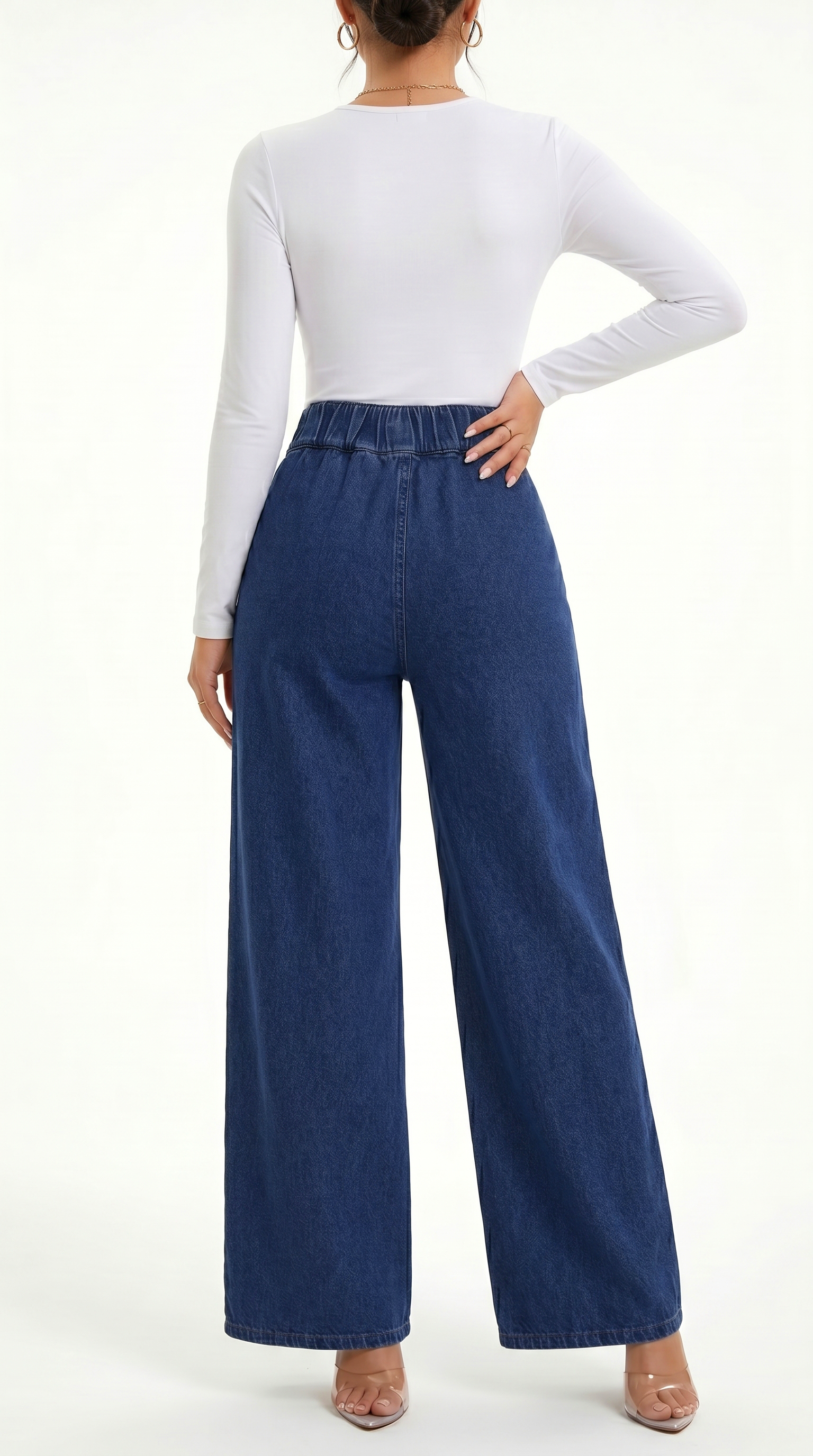 Person wearing blue wide-leg jeans and a white long-sleeve top on a white background, Straight Leg jeans from Meleche Fashion USA or Meléche (short as (Mé))