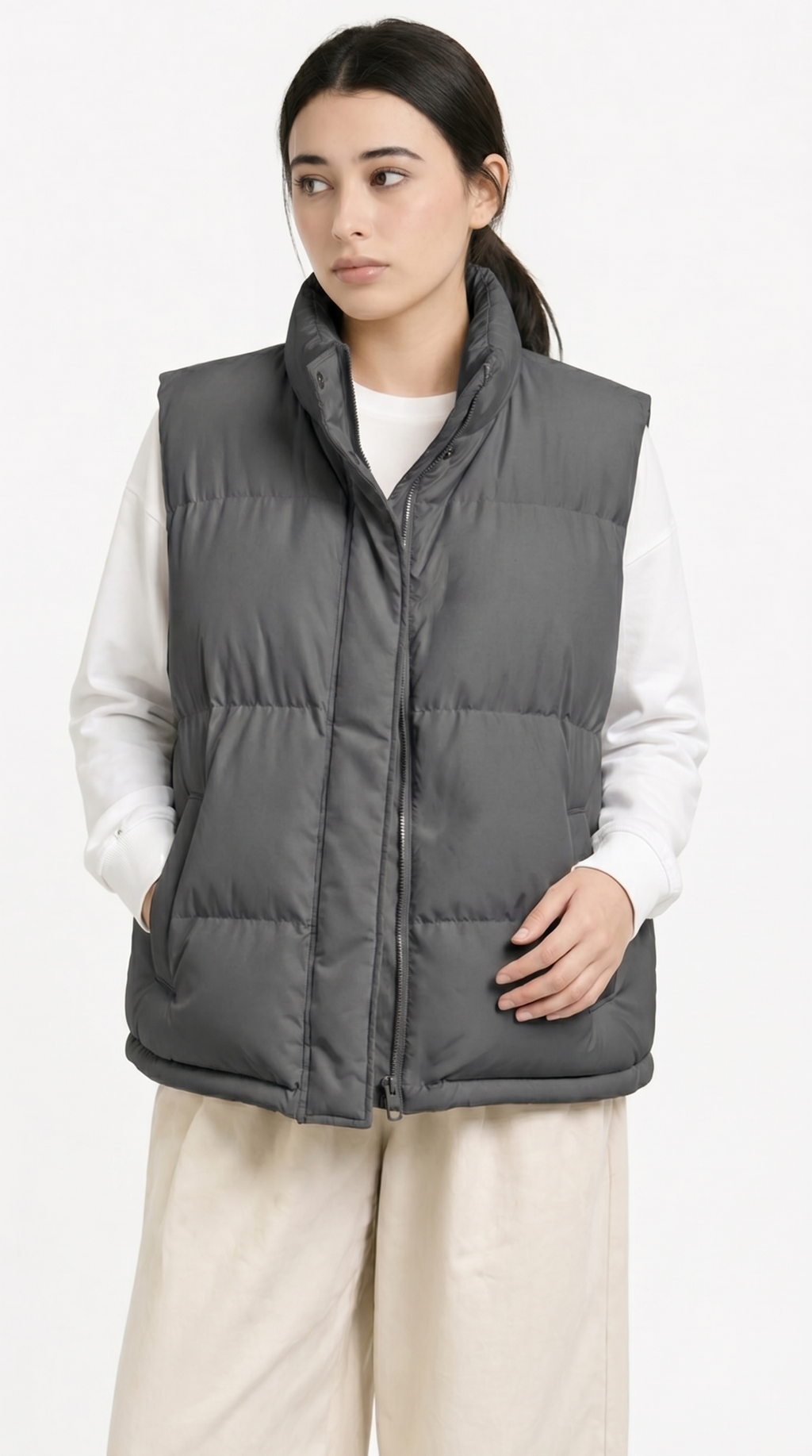 Person wearing a gray puffer vest over a white shirt on a white background from Meleche Fashion USA or Meléche (short as (Mé))