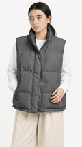 Person wearing a gray puffer vest over a white shirt on a white background from Meleche Fashion USA or Meléche (short as (Mé))