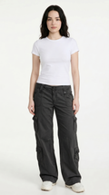 Woman wearing a white t-shirt and dark cargo pants on a white background, from Meleche Fashion USA or Meléche (short as (Mé))