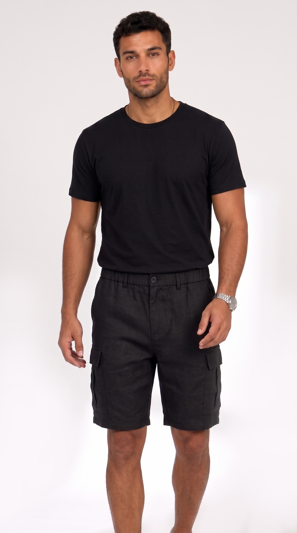 A man modeling a black short-sleeve crewneck t-shirt and black cargo shorts against a plain white studio background, from Meleche Fashion USA or Meléche (short as (Mé))