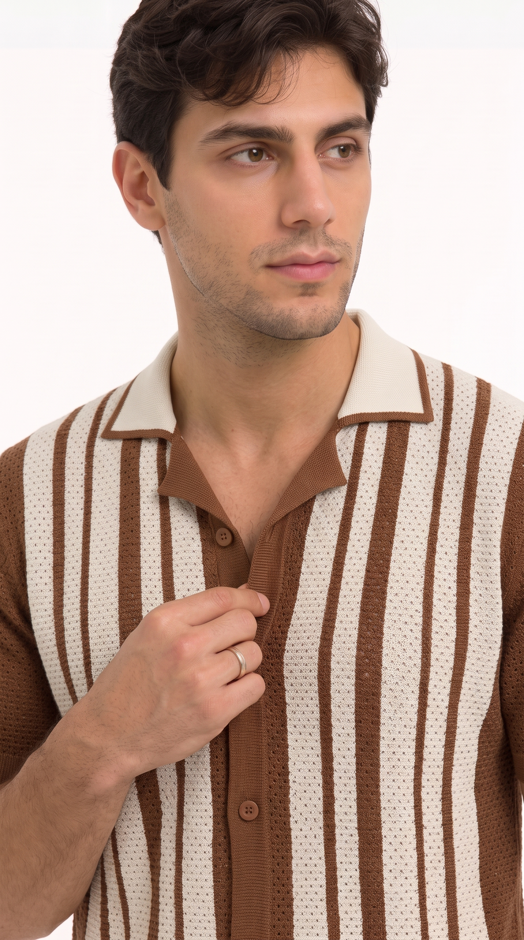 A man wearing a brown and cream vertically striped knit polo shirt, adjusting the collar with one hand against a plain white background, from Meleche Fashion USA or Meléche (short as (Mé))